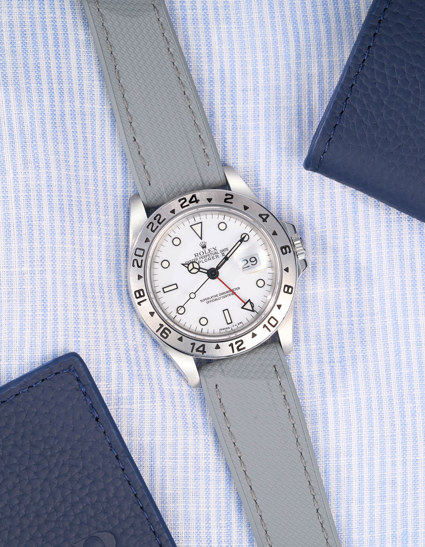 Flat lay of Grey Straight End FKM Rubber Strap 20mm placed on a blue and white shirt