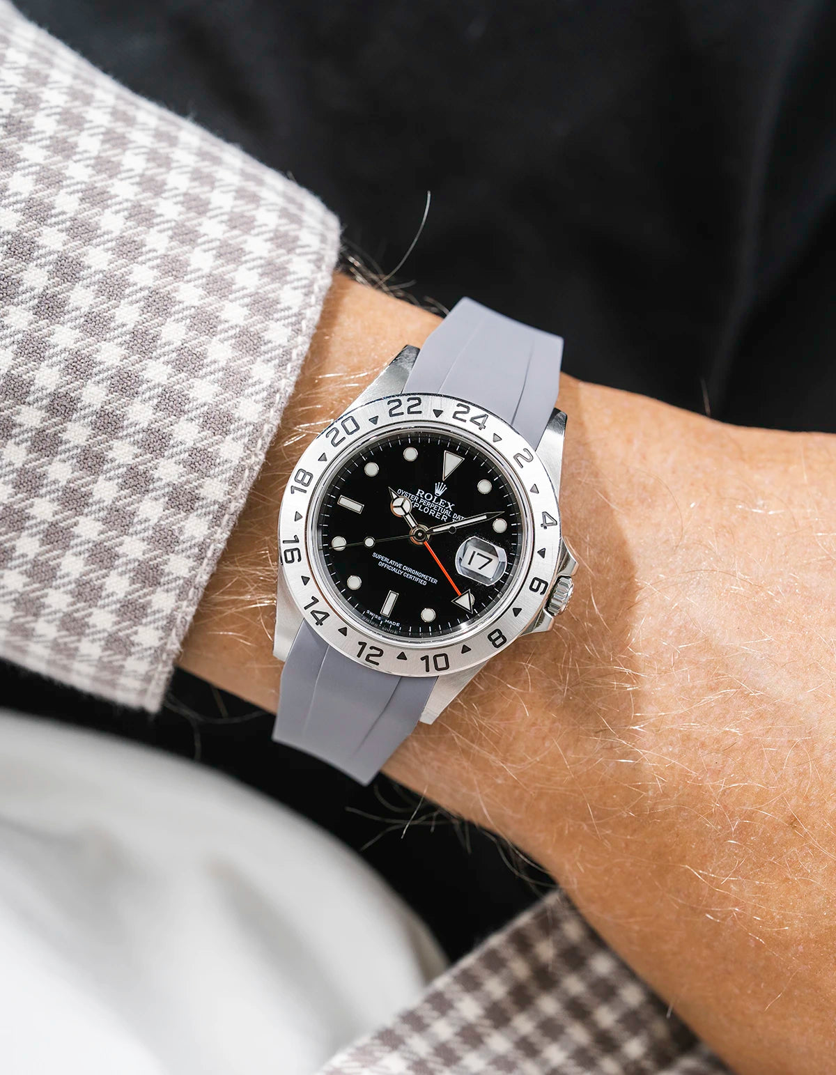 Close-up of a person wearing a Rolex Explorer 2 16570 model watch with a white beige jacket sleeve and a grey FKM rubber watch strap from Wristbuddys