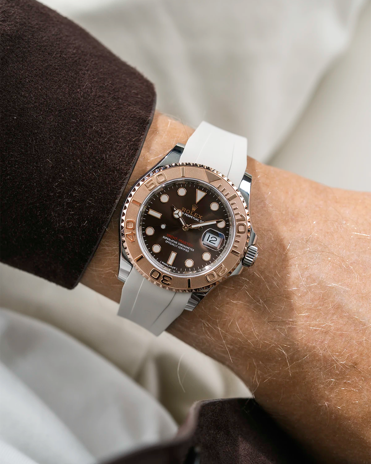 Close-up of a person wearing a Rolex YachtMaster 2 126622 / 116622 model watch with a brown shirt sleeve and a beige FKM rubber watch strap from Wristbuddys