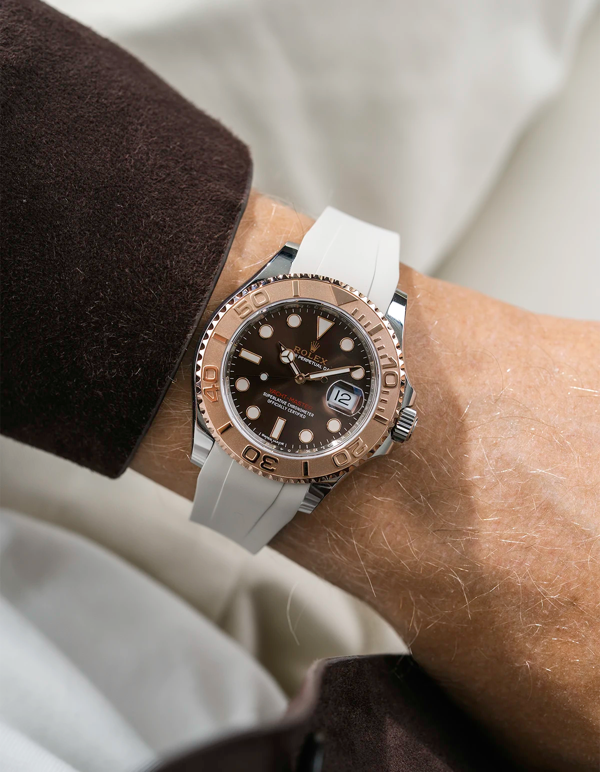 Close-up of a person wearing a Rolex YachtMaster 2 126622 / 116622 model watch with a brown shirt sleeve and a beige FKM rubber watch strap from Wristbuddys