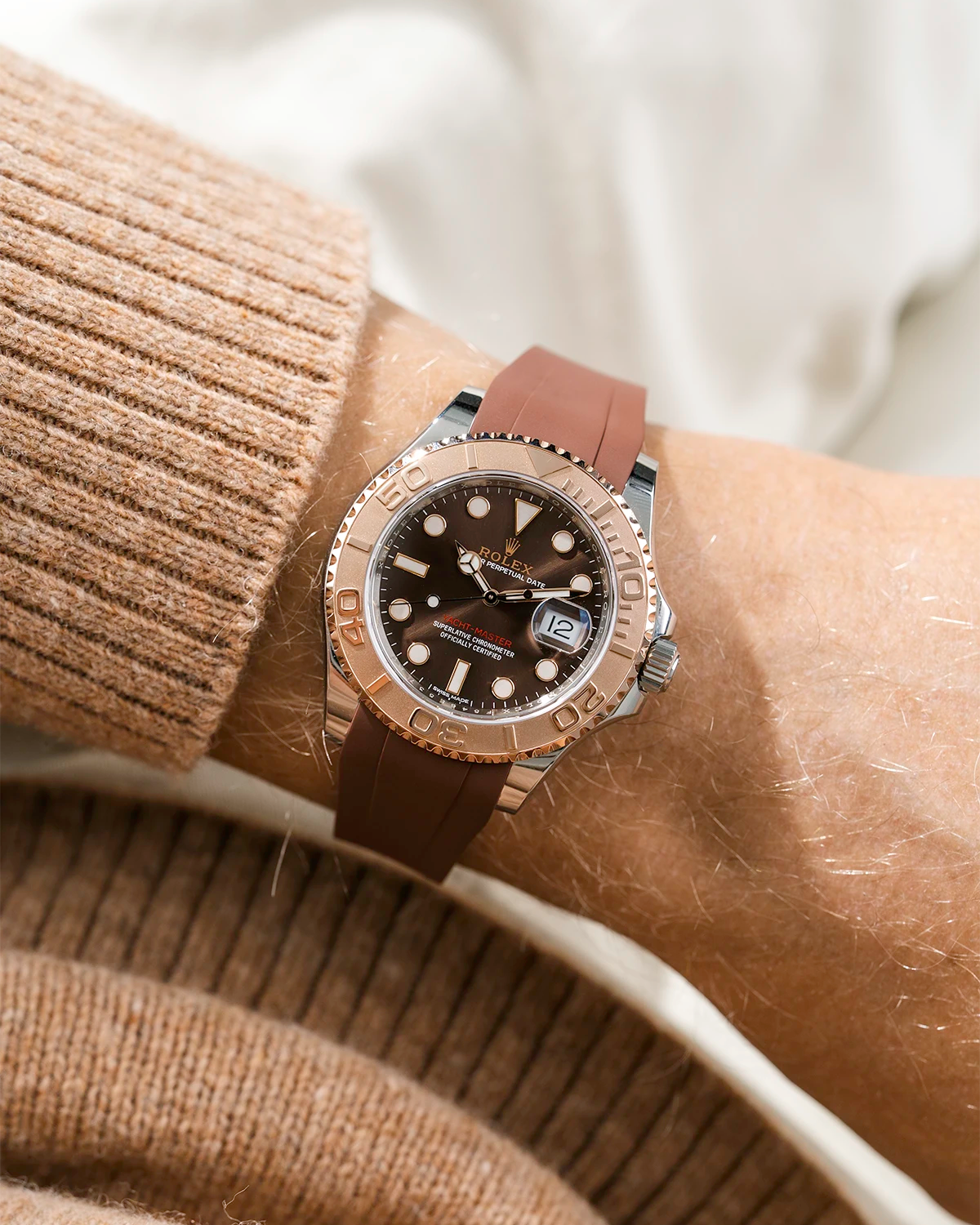 Close-up of a person wearing a Rolex YachtMaster 2 126622 / 116622 model watch with a brown shirt sleeve and a brown FKM rubber watch strap from Wristbuddys