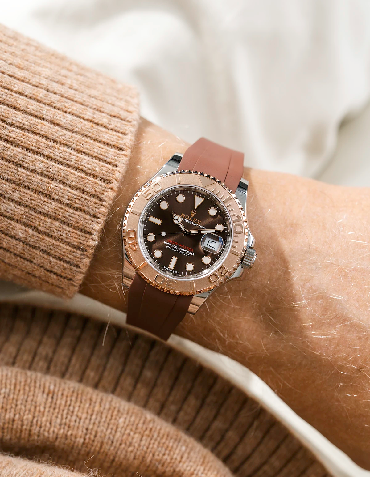 Close-up of a person wearing a Rolex YachtMaster 2 126622 / 116622 model watch with a brown shirt sleeve and a brown FKM rubber watch strap from Wristbuddys