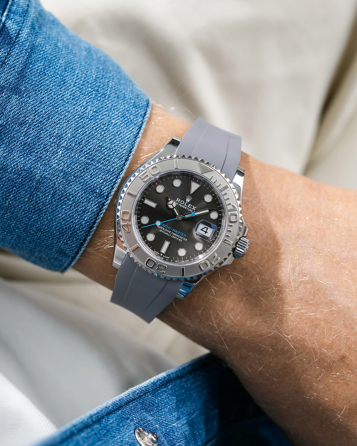 Close-up of a person wearing a Rolex YachtMaster 2 126622 / 116622 model watch with a blue shirt sleeve and a grey FKM rubber watch strap from Wristbuddys