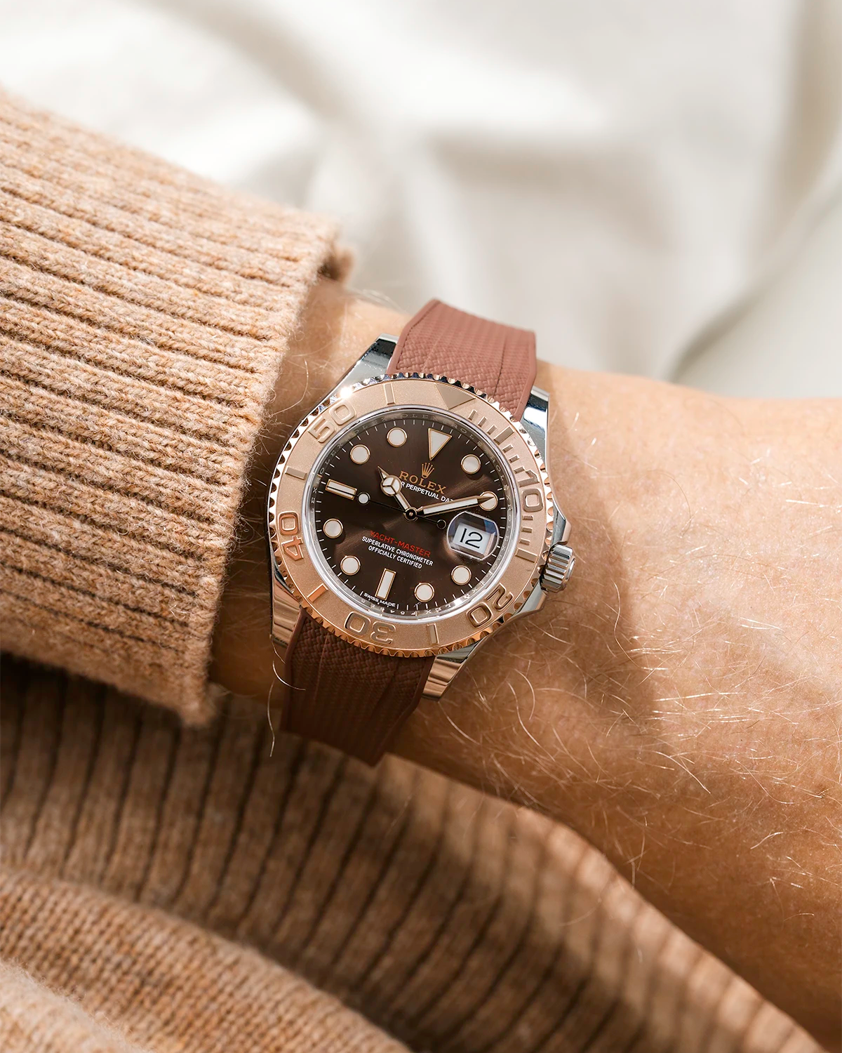 Close-up of a person wearing a Rolex YachtMaster 2 126622 / 116622 model watch with a brown shirt sleeve and a Capri brown Vertech FKM rubber watch strap from Wristbuddys