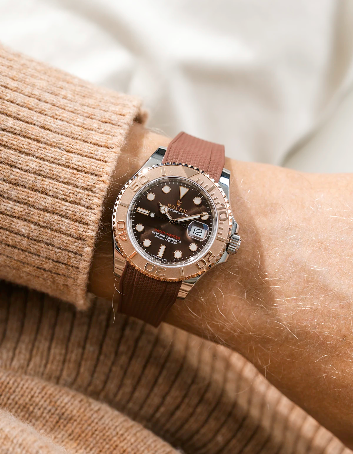 Close-up of a person wearing a Rolex YachtMaster 2 126622 / 116622 model watch with a brown shirt sleeve and a Capri brown Vertech FKM rubber watch strap from Wristbuddys