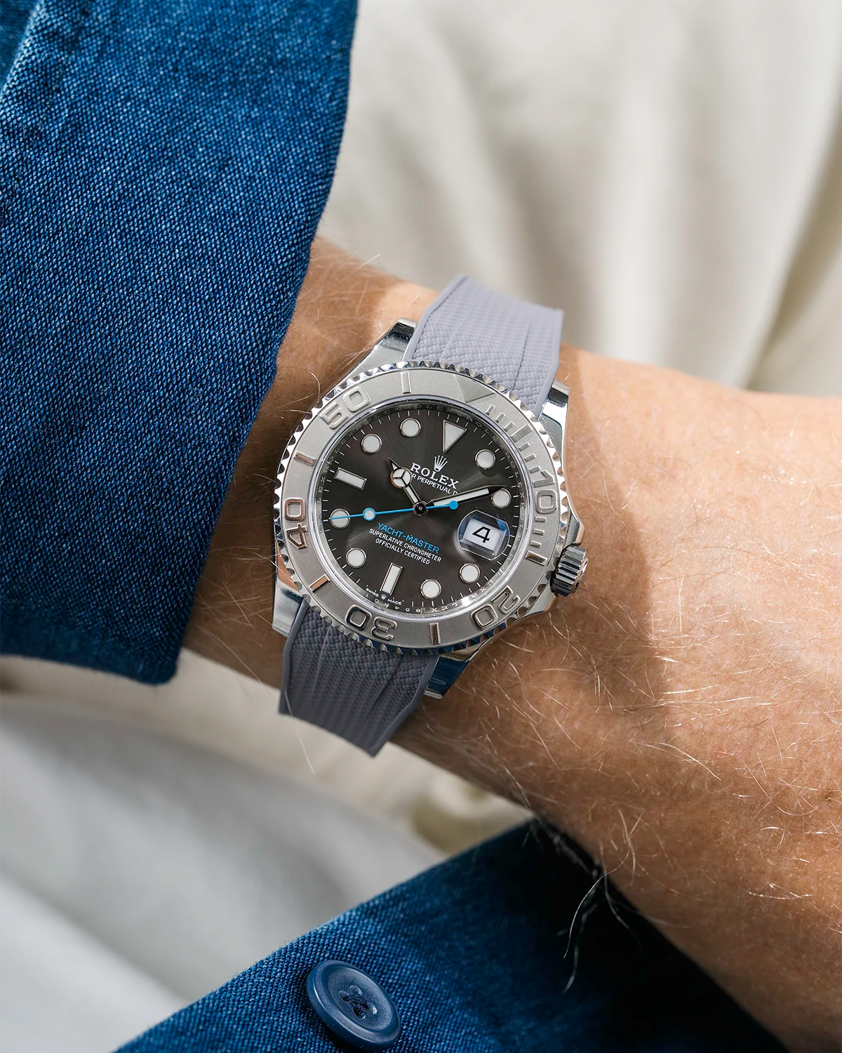 Close-up of a person wearing a Rolex YachtMaster 2 126622 / 116622 model watch with a blue shirt sleeve and a Capri grey Vertech FKM rubber watch strap from Wristbuddys