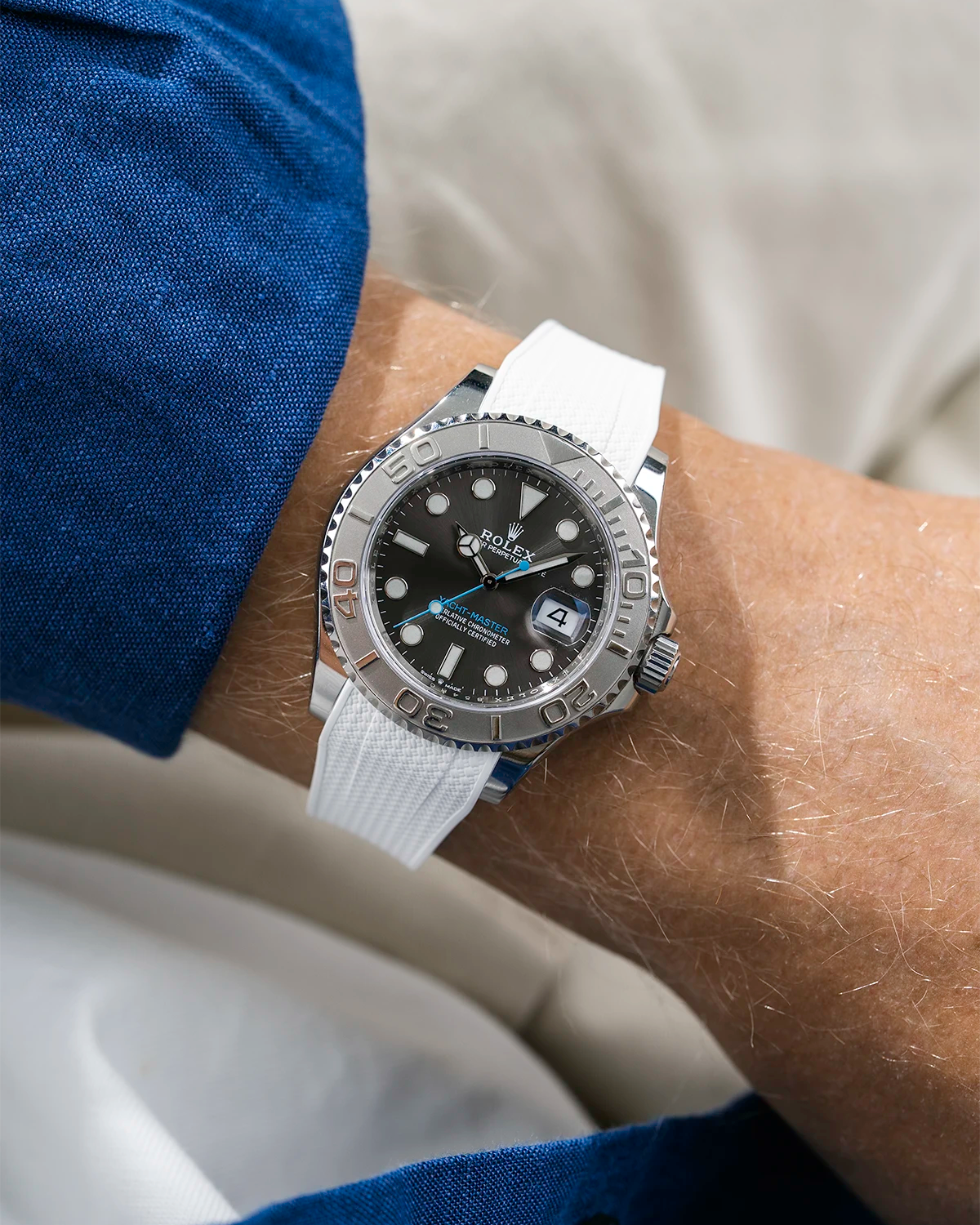 Close-up of a person wearing a Rolex YachtMaster 2 126622 / 116622 model watch with a blue shirt sleeve and a Capri white Vertech FKM rubber watch strap from Wristbuddys