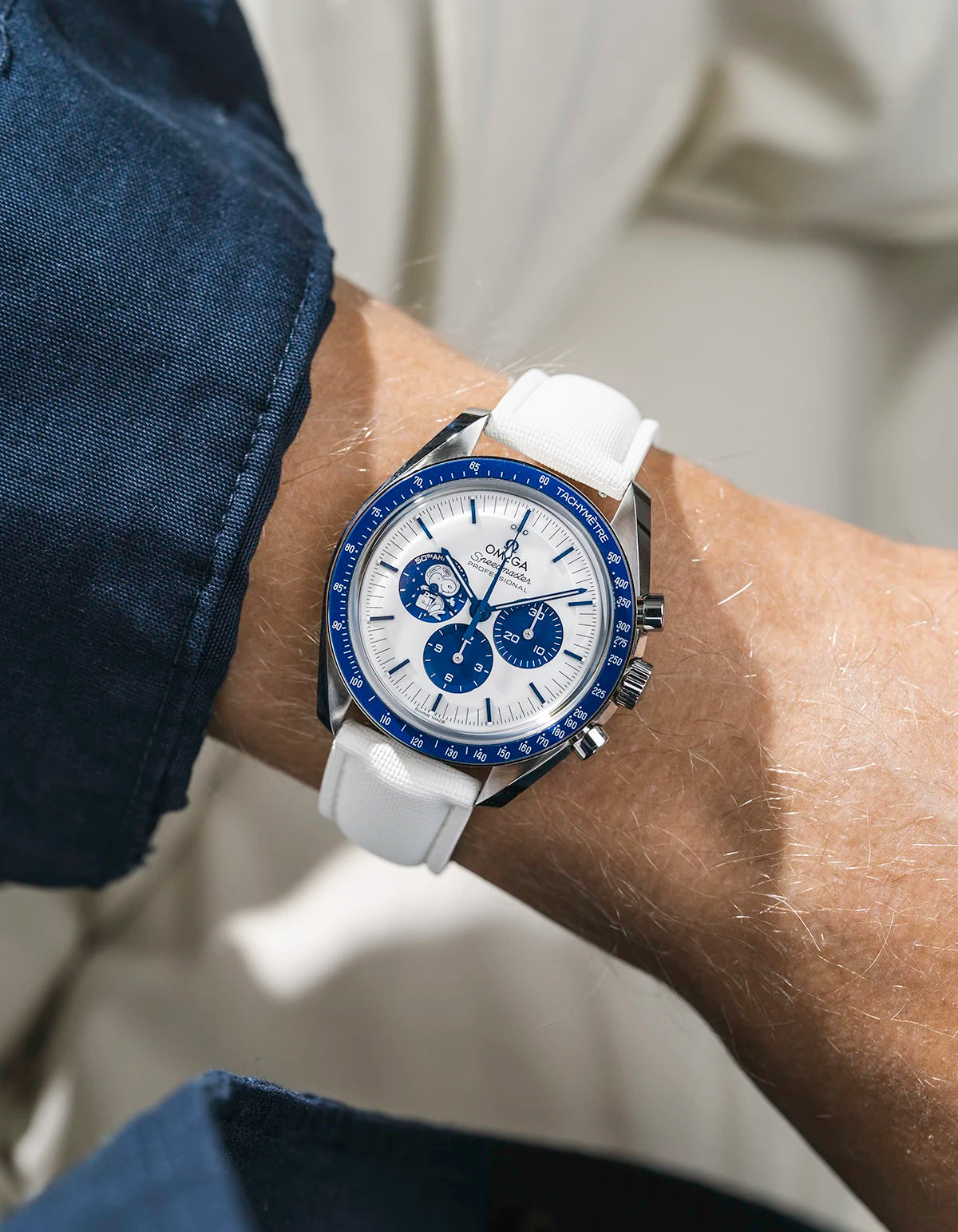 Sailcloth FKM Rubber Strap in White With Deployant Clasp wrist shot on Omega Speedmaster Snoopy watch