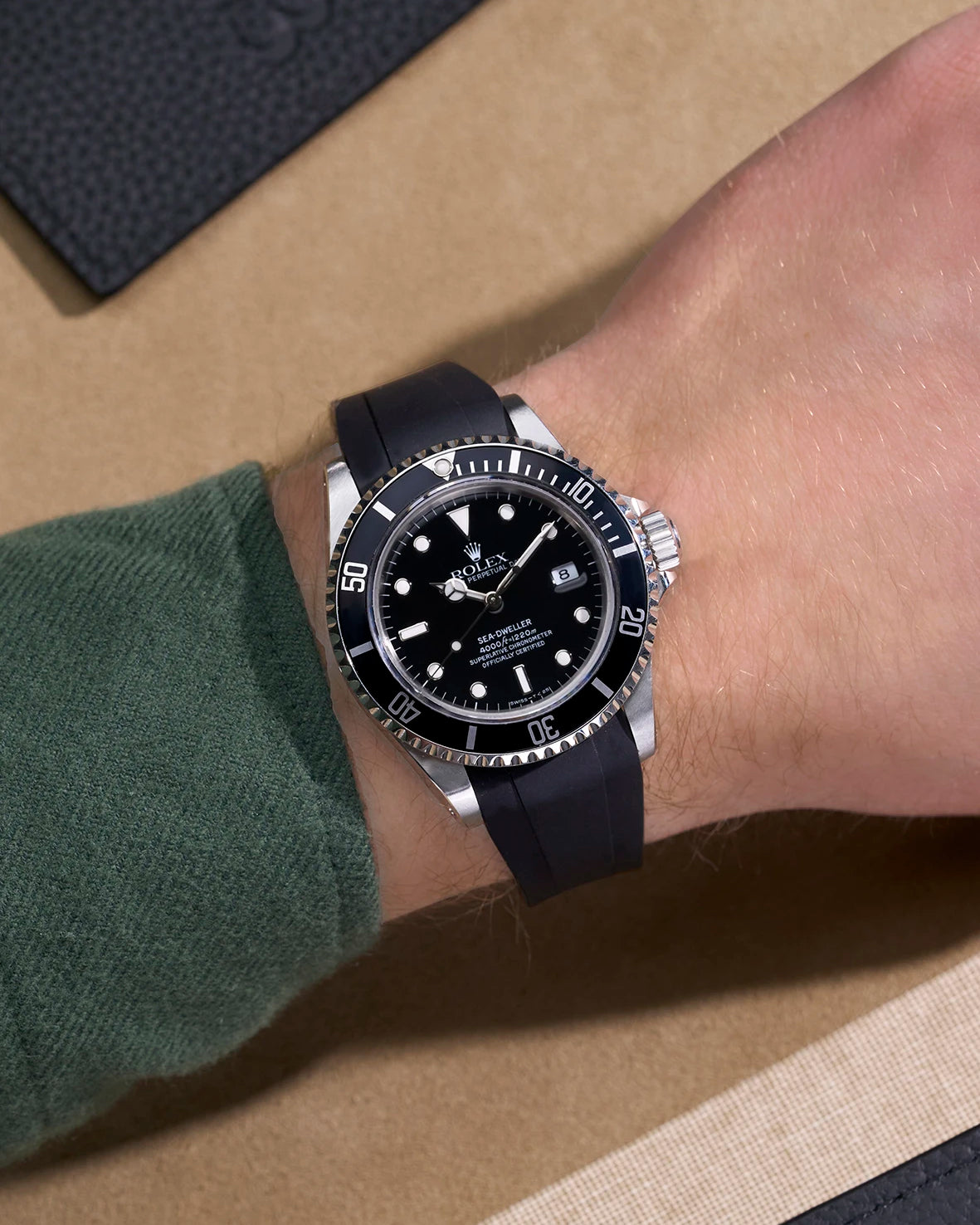 Rolex Sea-Dweller 16600 on wrist with integrated black rubber strap and original clasp