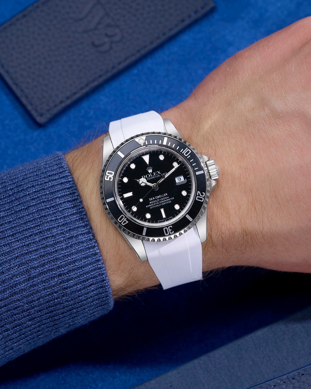 Wrist shot of Rolex Sea-Dweller 16600 fitted with white FKM rubber strap and original clasp integration
