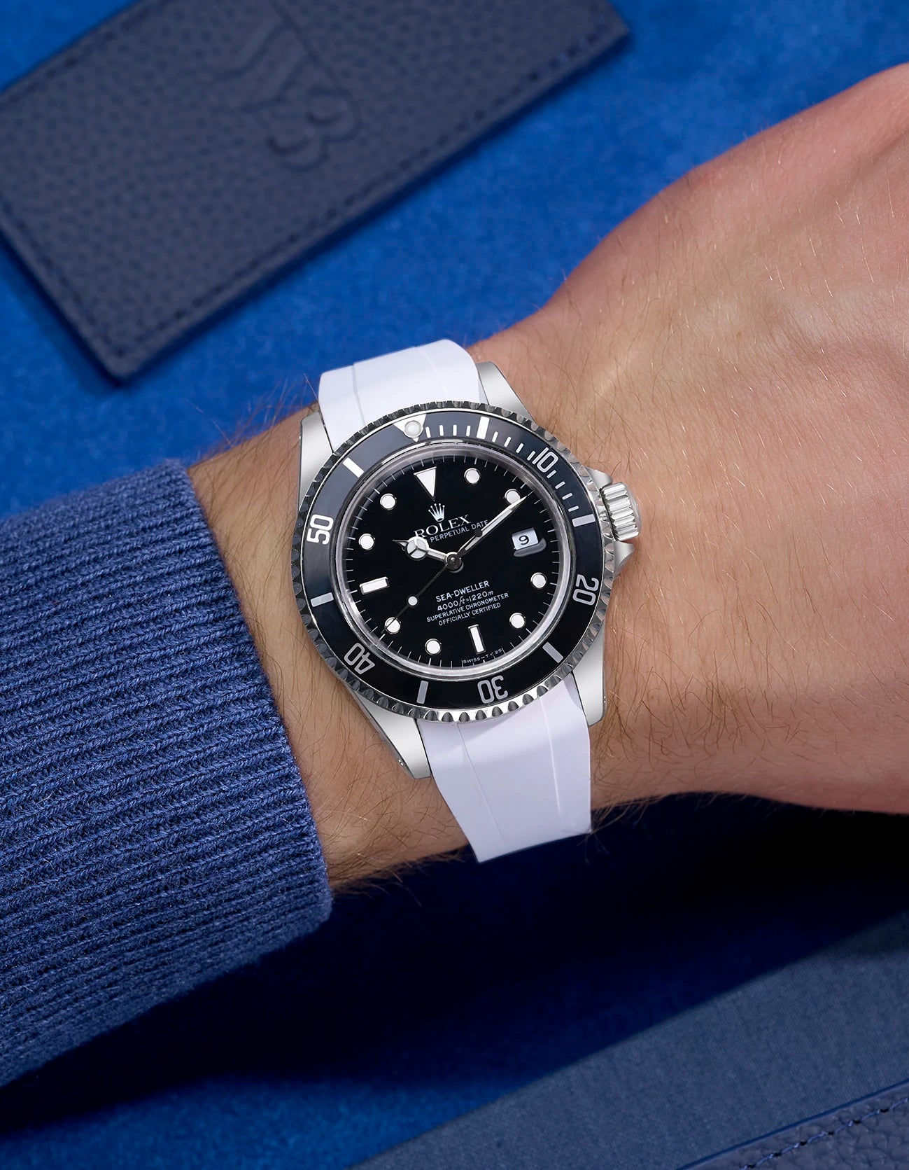 Wrist shot of Rolex Sea-Dweller 16600 fitted with white FKM rubber strap and original clasp integration