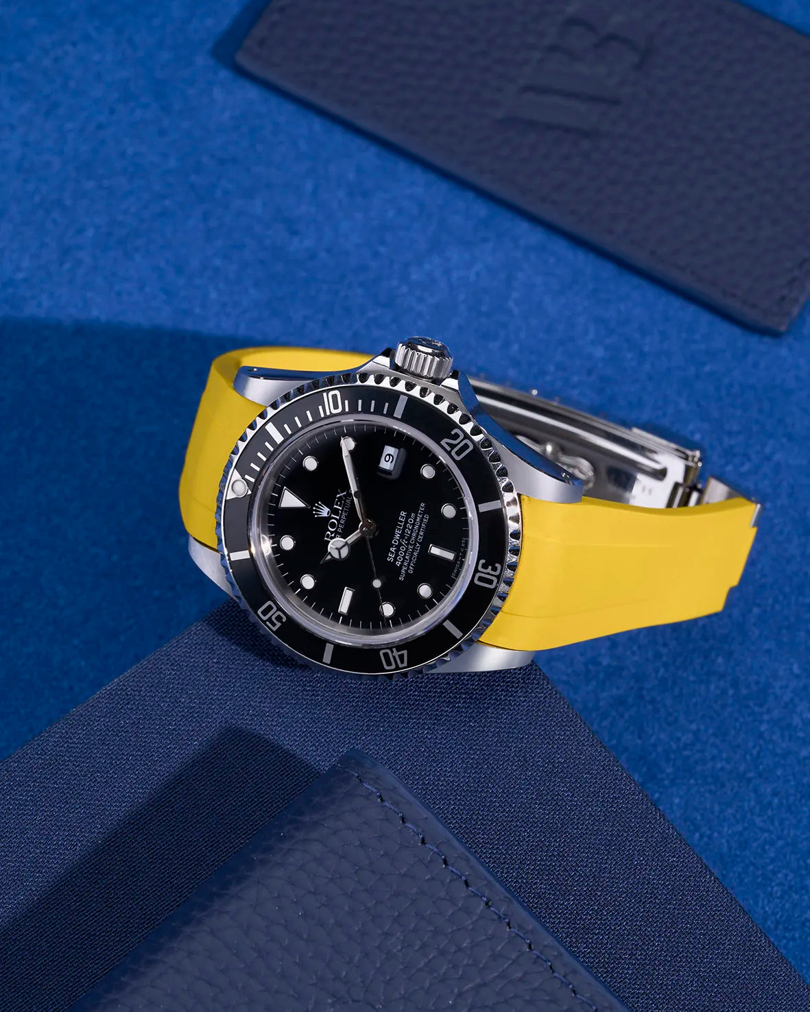 Rolex Sea-Dweller 16600 on yellow FKM rubber strap – original clasp integration shown in flat lay