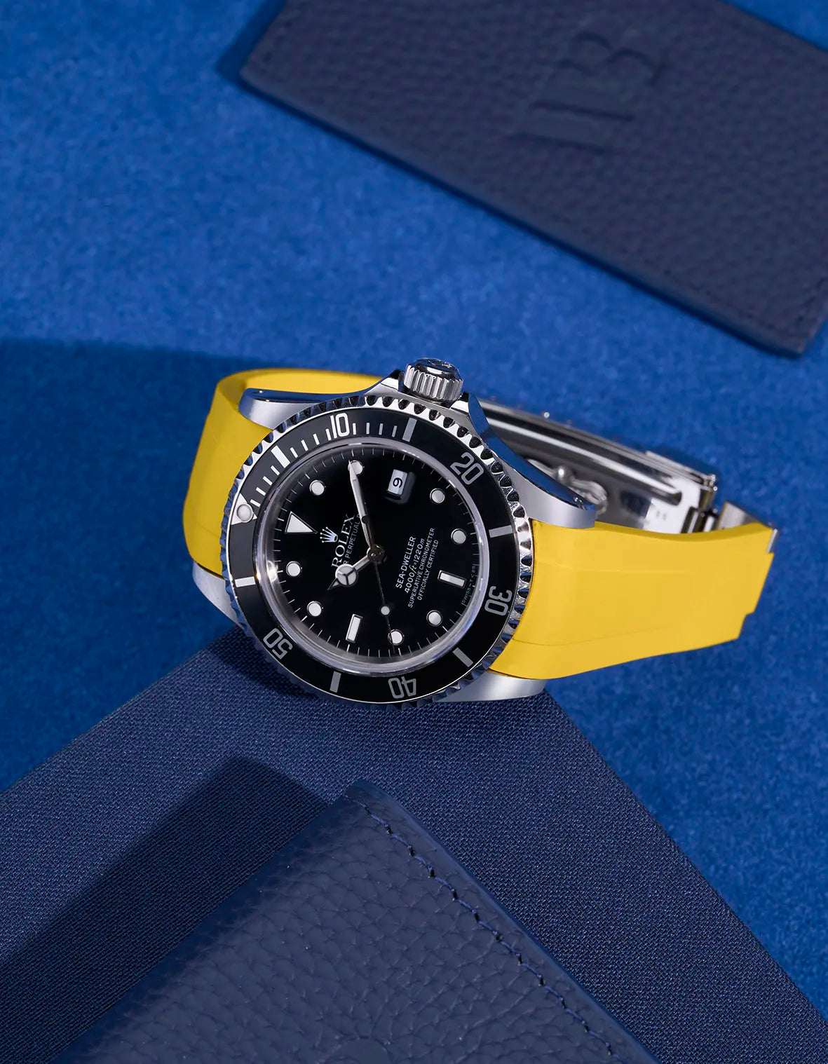 Rolex Sea-Dweller 16600 on yellow FKM rubber strap – original clasp integration shown in flat lay