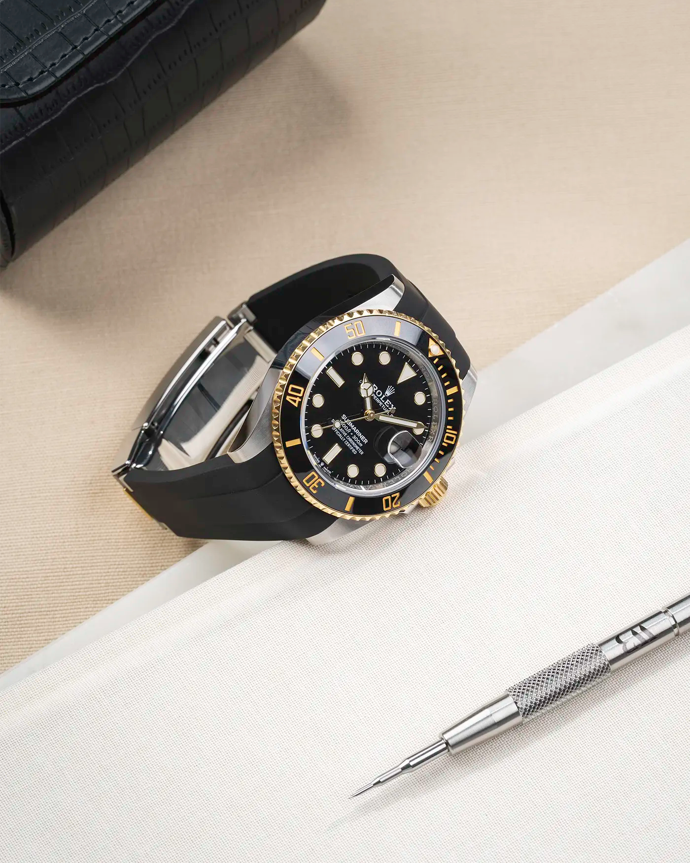 Product image of Rolex Submariner 41 with black FKM Rubber Strap fitted on the watch, integrated with original clasp – angled front shot with clasp closed