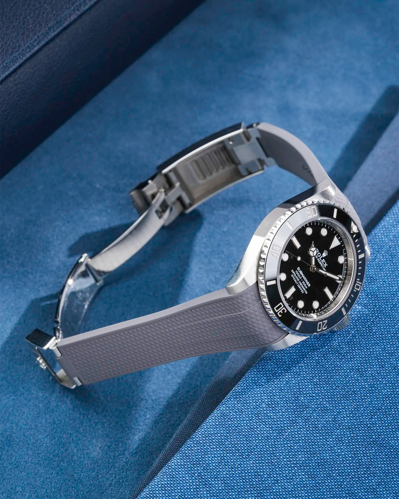 Product photo of Rolex Submariner 41 with grey Vertech FKM Rubber Strap mounted on the watch, integrated with original clasp – side angle view showing clasp open