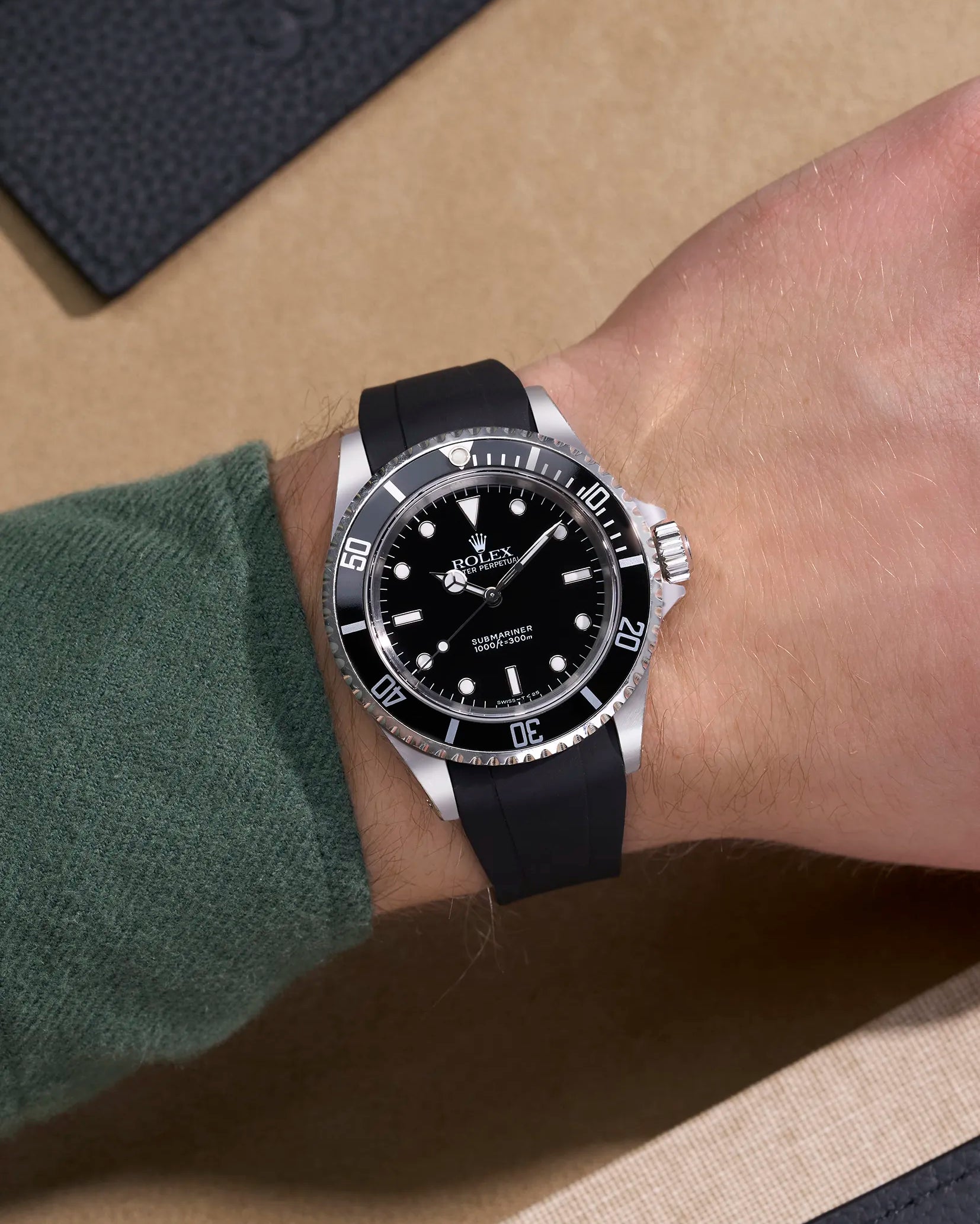 Wrist shot of Rolex Submariner 14060/16610 fitted with black curved FKM strap and original clasp – elegant fit and matte finish
