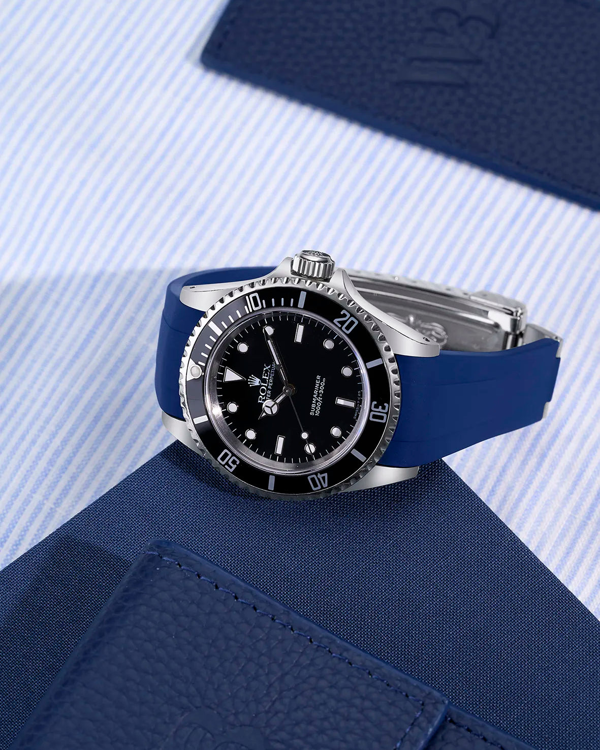Rolex Submariner 16610/14060 with integrated blue rubber strap and original clasp – flat lay presentation