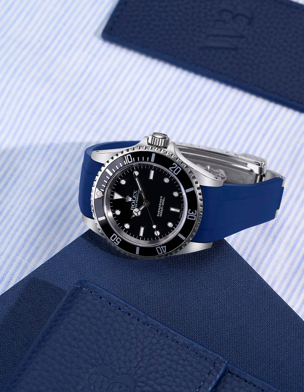 Rolex Submariner 16610/14060 with integrated blue rubber strap and original clasp – flat lay presentation