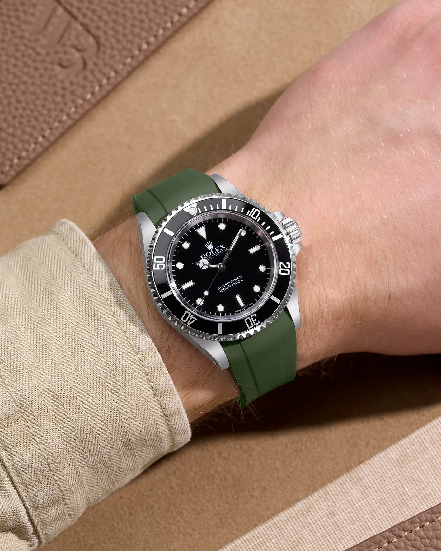Wrist shot of Rolex Submariner 16610 and 14060 on green FKM rubber strap – integrated for original clasp compatibility