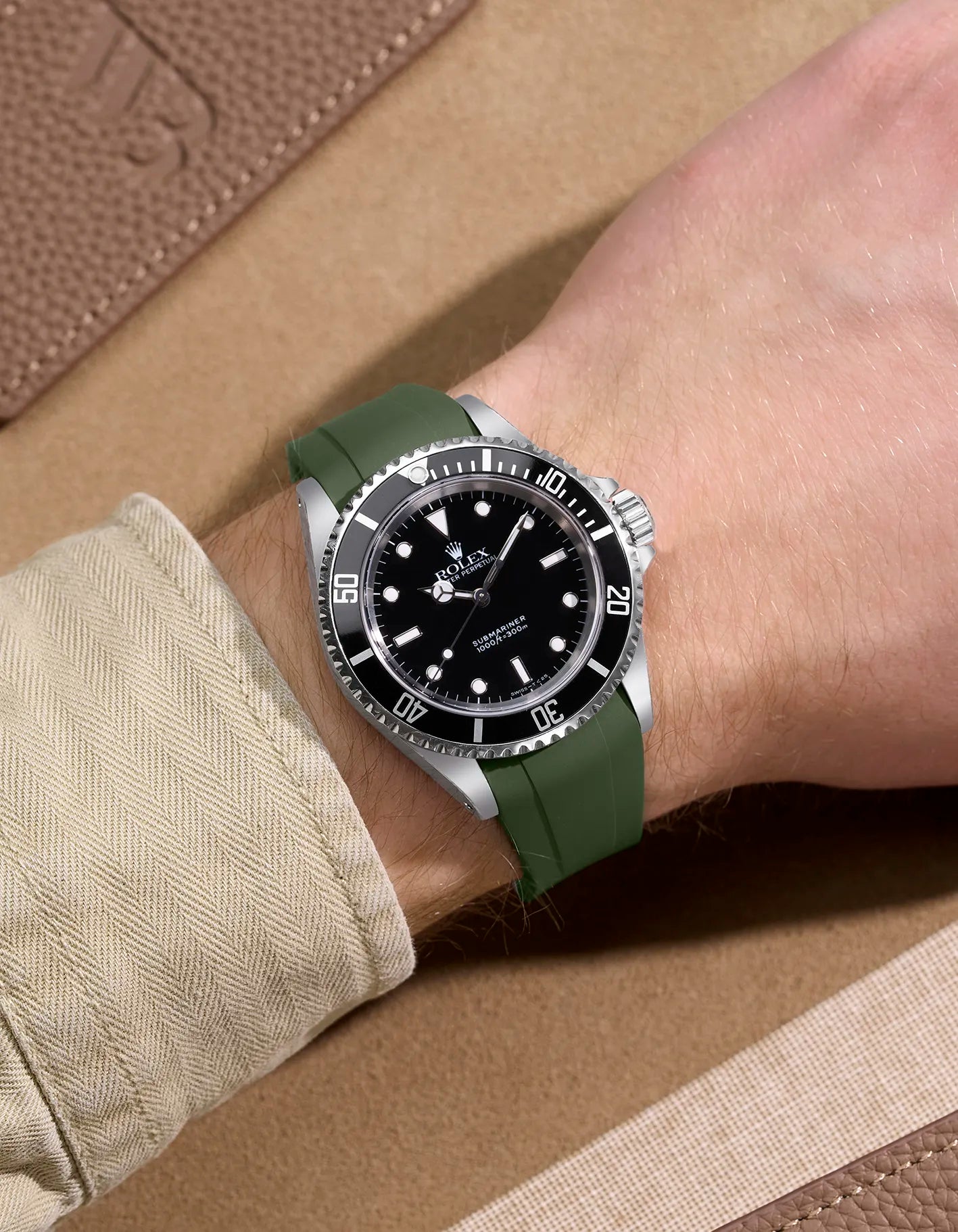Wrist shot of Rolex Submariner 16610 and 14060 on green FKM rubber strap – integrated for original clasp compatibility
