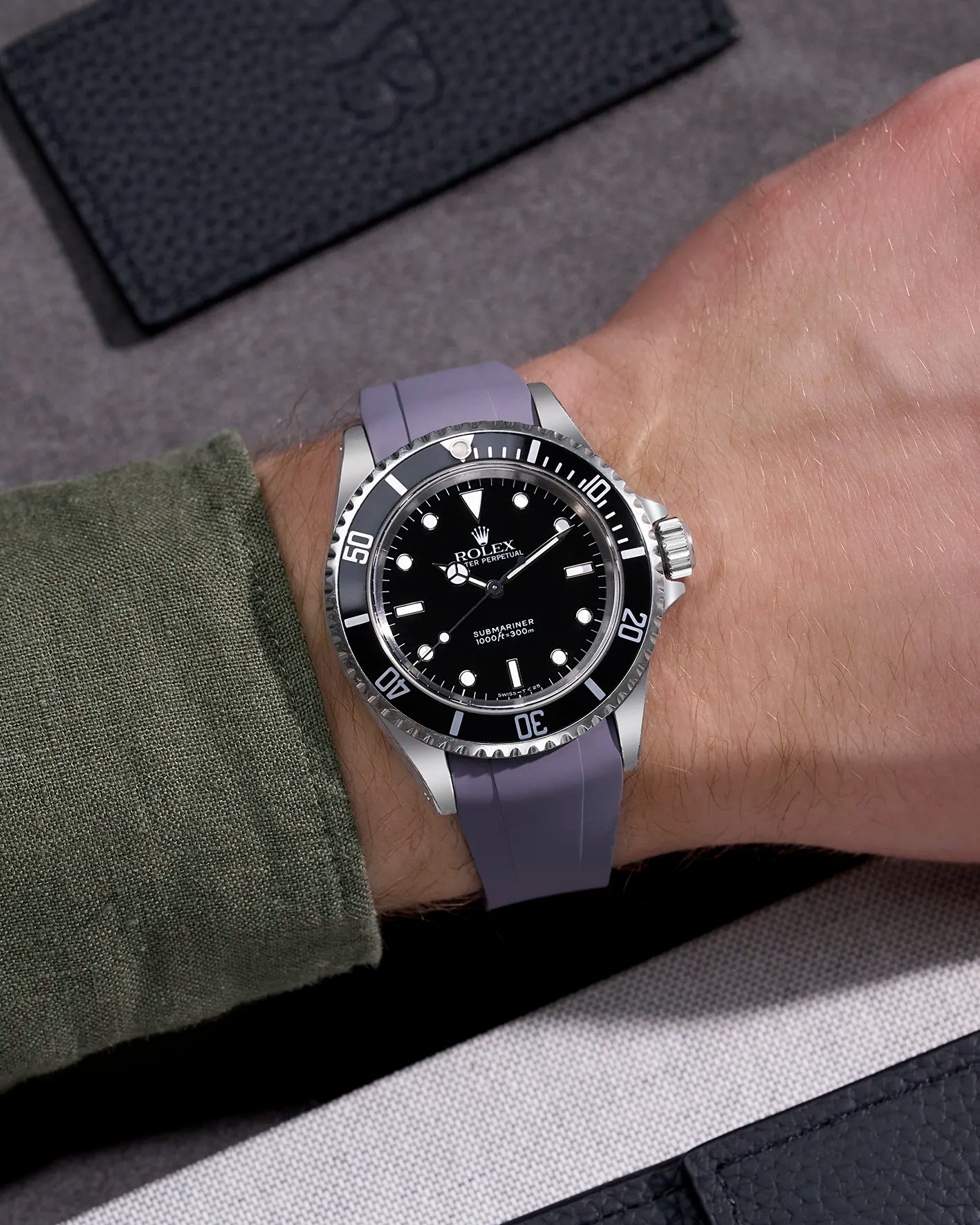 Wrist shot of Rolex Submariner 16610 and 14060 on grey FKM rubber strap integrated with original clasp