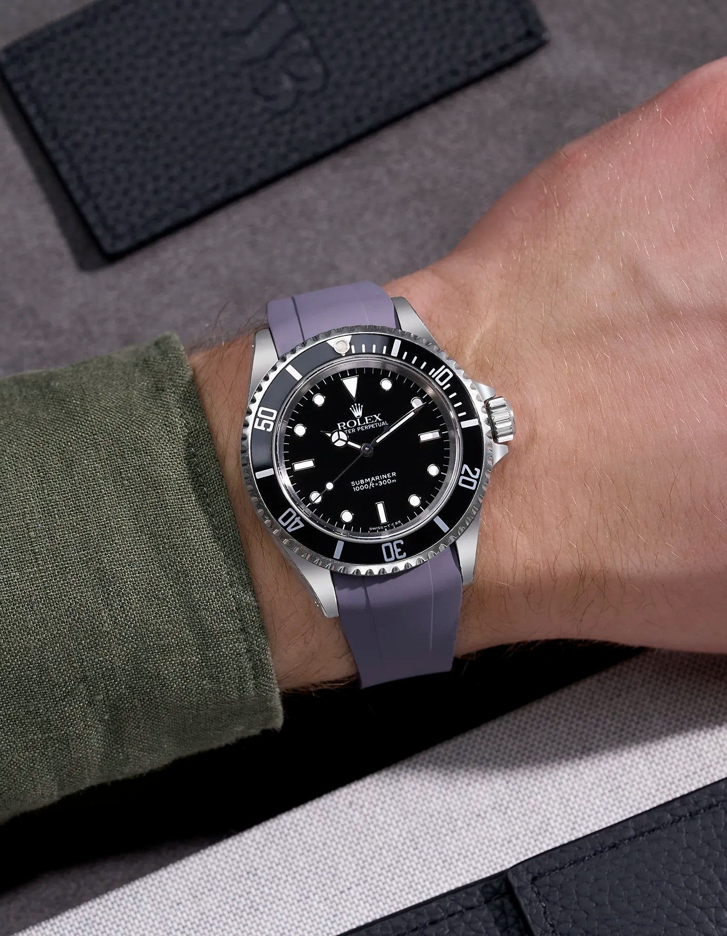 Wrist shot of Rolex Submariner 16610 and 14060 on grey FKM rubber strap integrated with original clasp