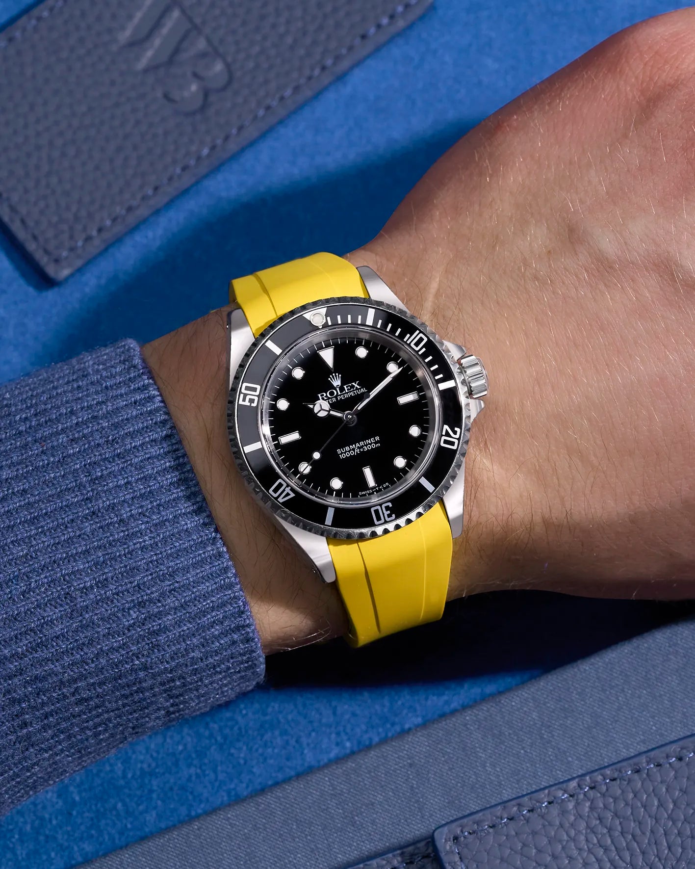 Rolex Submariner 16610 and 14060 on wrist with integrated yellow FKM rubber strap and original Rolex clasp