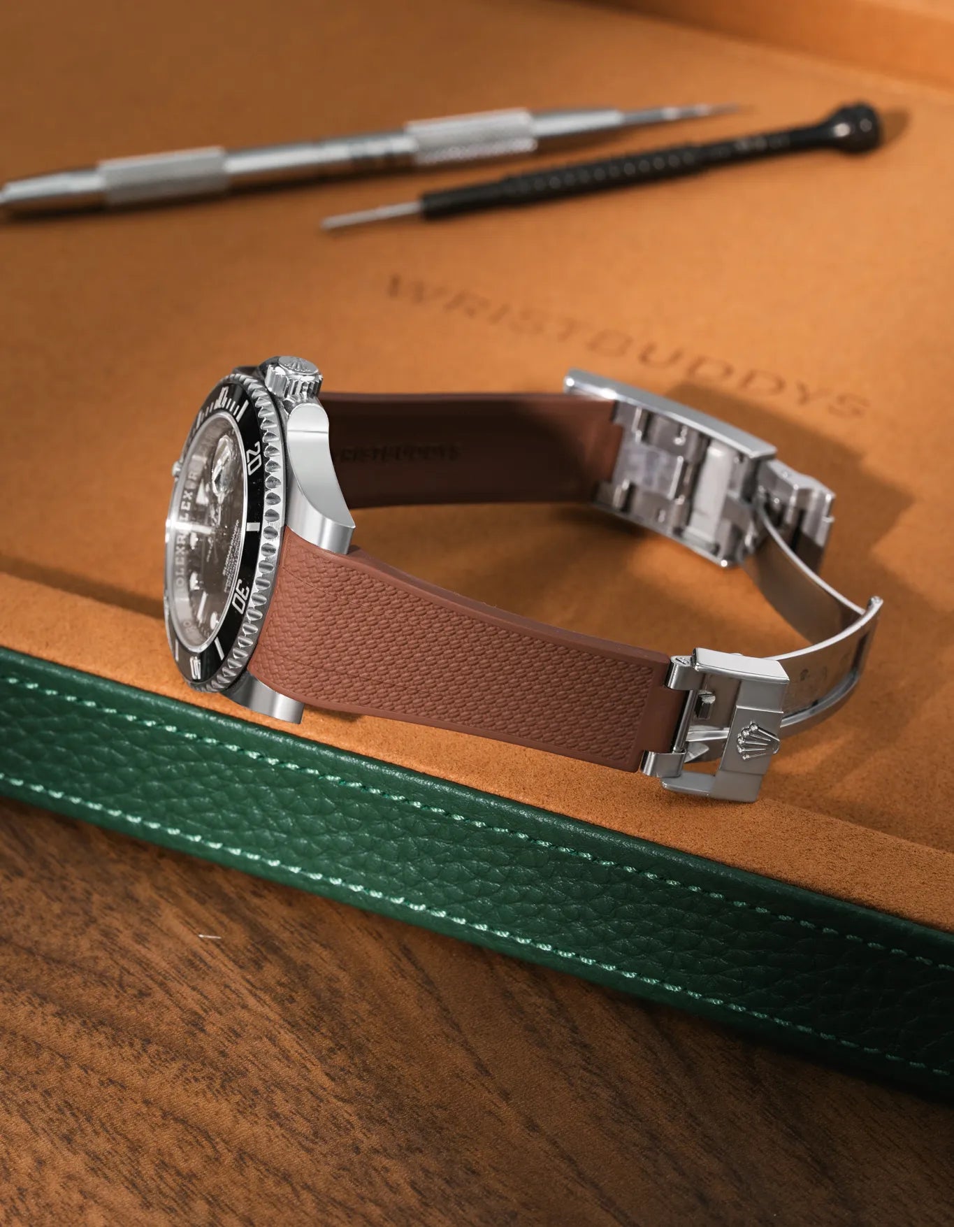 Brown textured FKM rubber watch band for Rolex Submariner 116610 and 126610, premium integrated design for original clasp, shown on a brown leather tray.