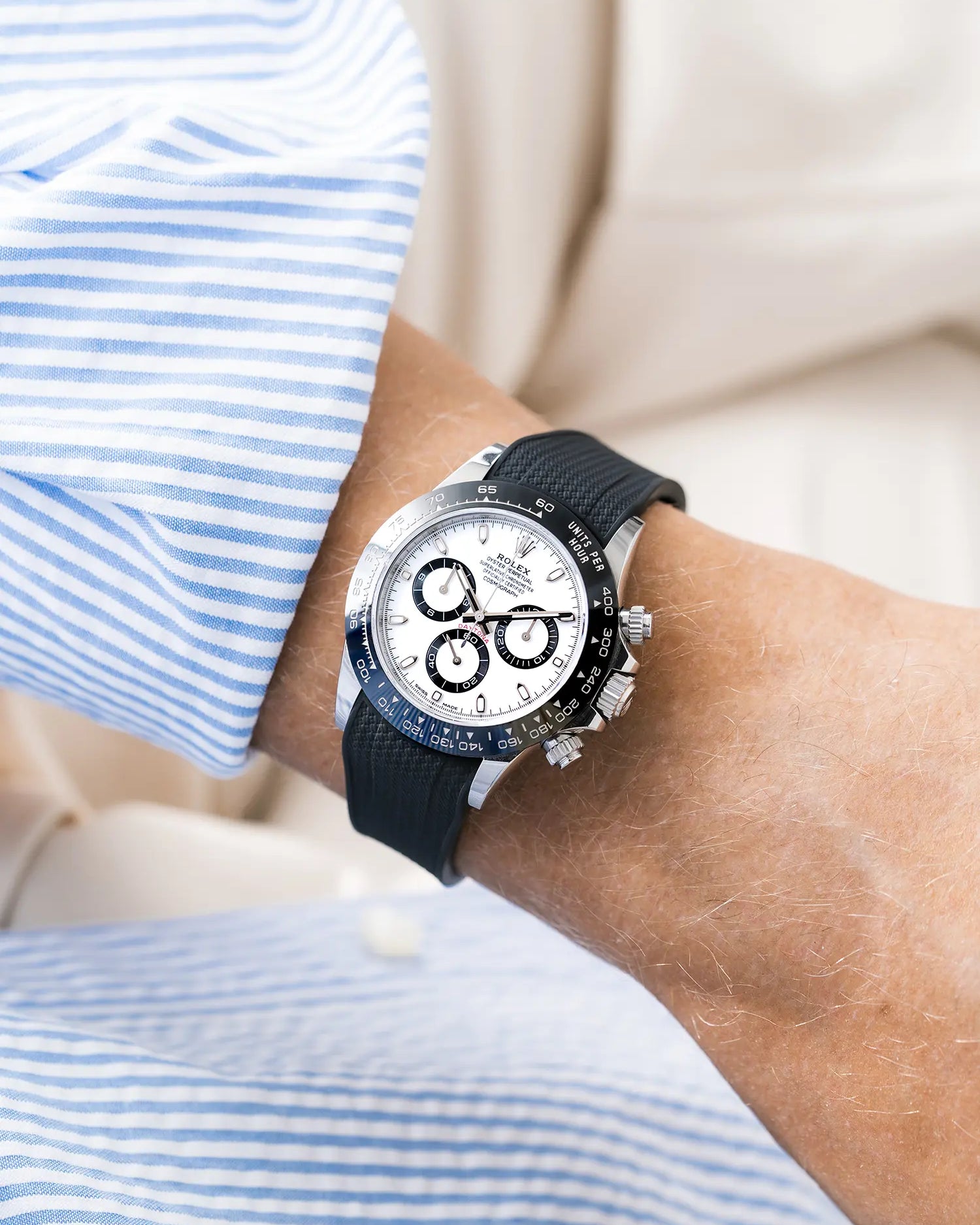 Vertech black integrated FKM rubber strap with original clasp on Rolex Daytona 116500 white dial ceramic bezel wrist shot with blue and white shirt