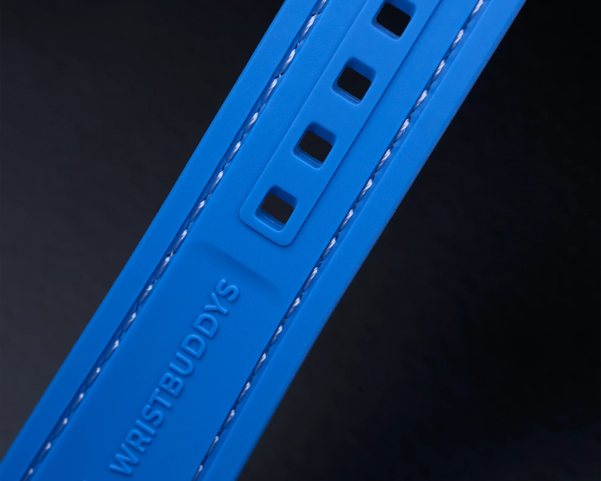 Blue Vertech Rubber Strap with reinforced sizing holes and WRISTBUDDYS logo – durability detail