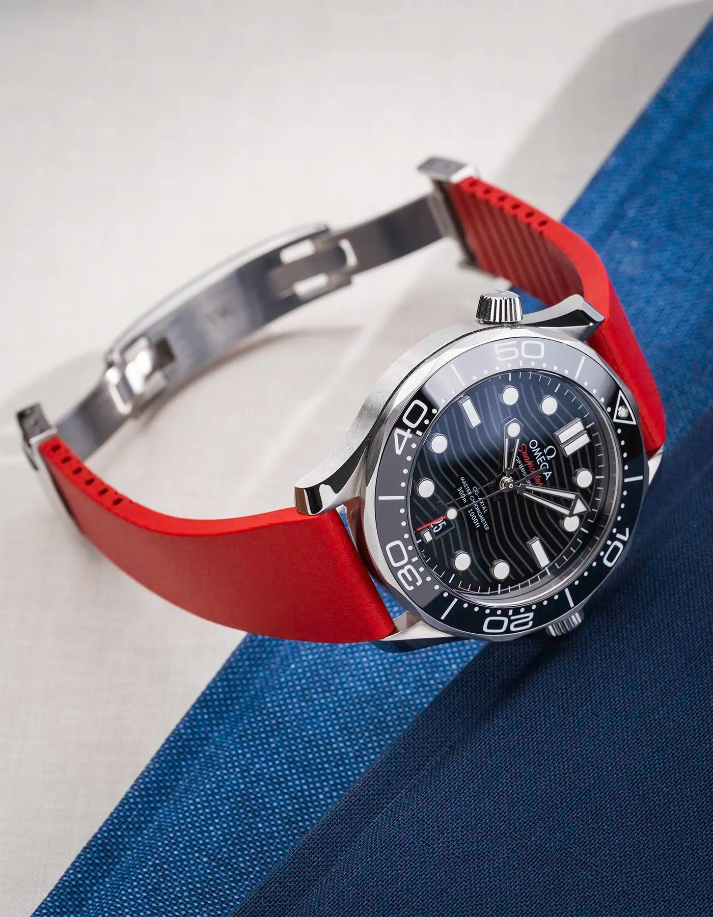 Red CTS FKM Rubber Strap 19-22mm lying on a table showing the strap's fit with the clasp open