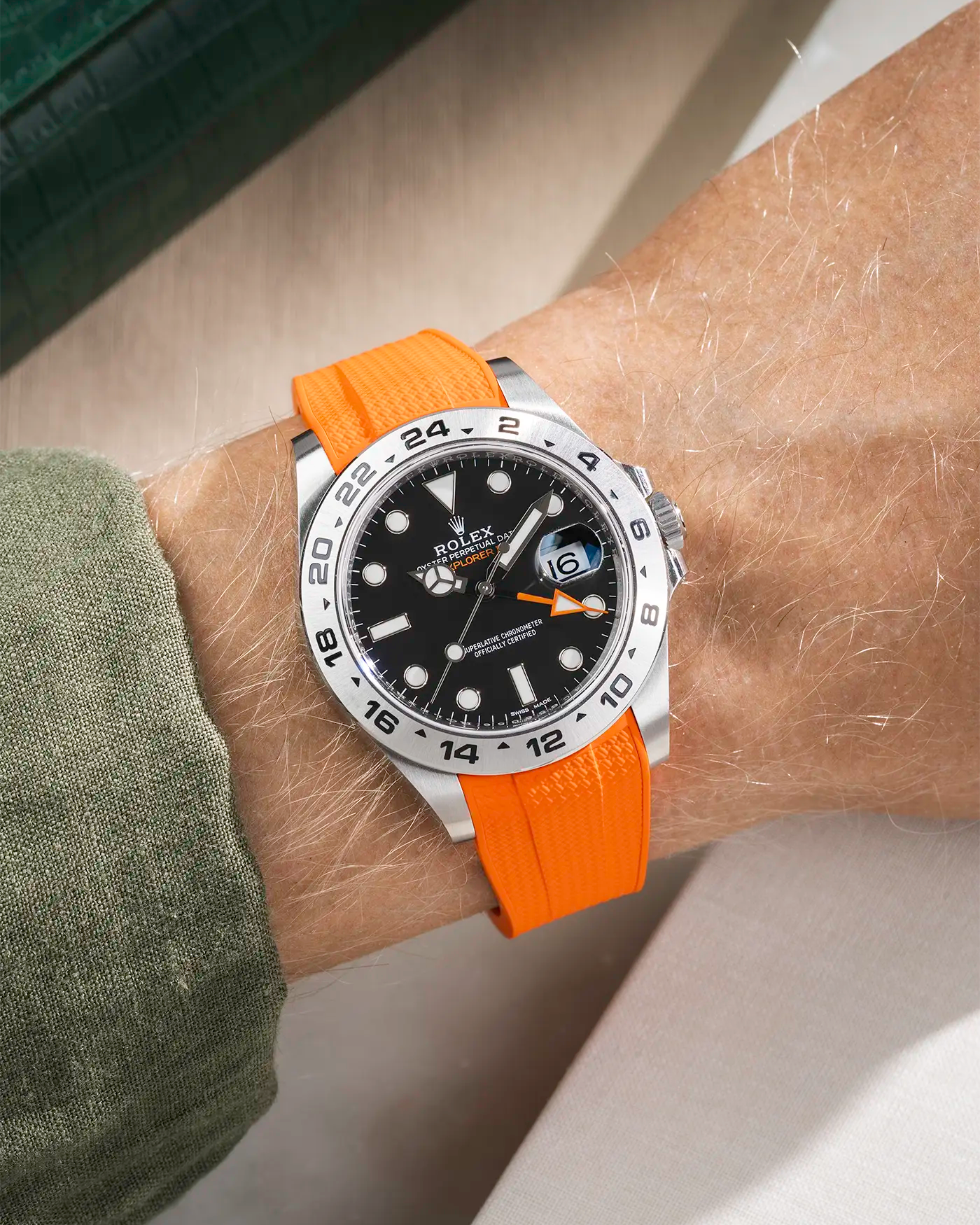 Wrist shot on Vertech FKM Rubber Strap in orange with Integrated Original Clasp - Rolex Explorer 216570 on beige background