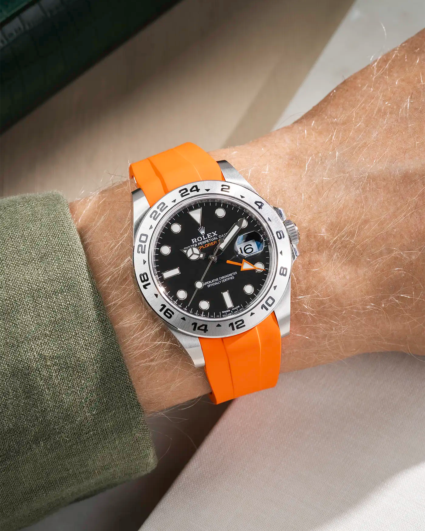 Wrist shot on orange FKM Rubber Strap Integrated with Original Clasp - Rolex Explorer 216570 over beige table