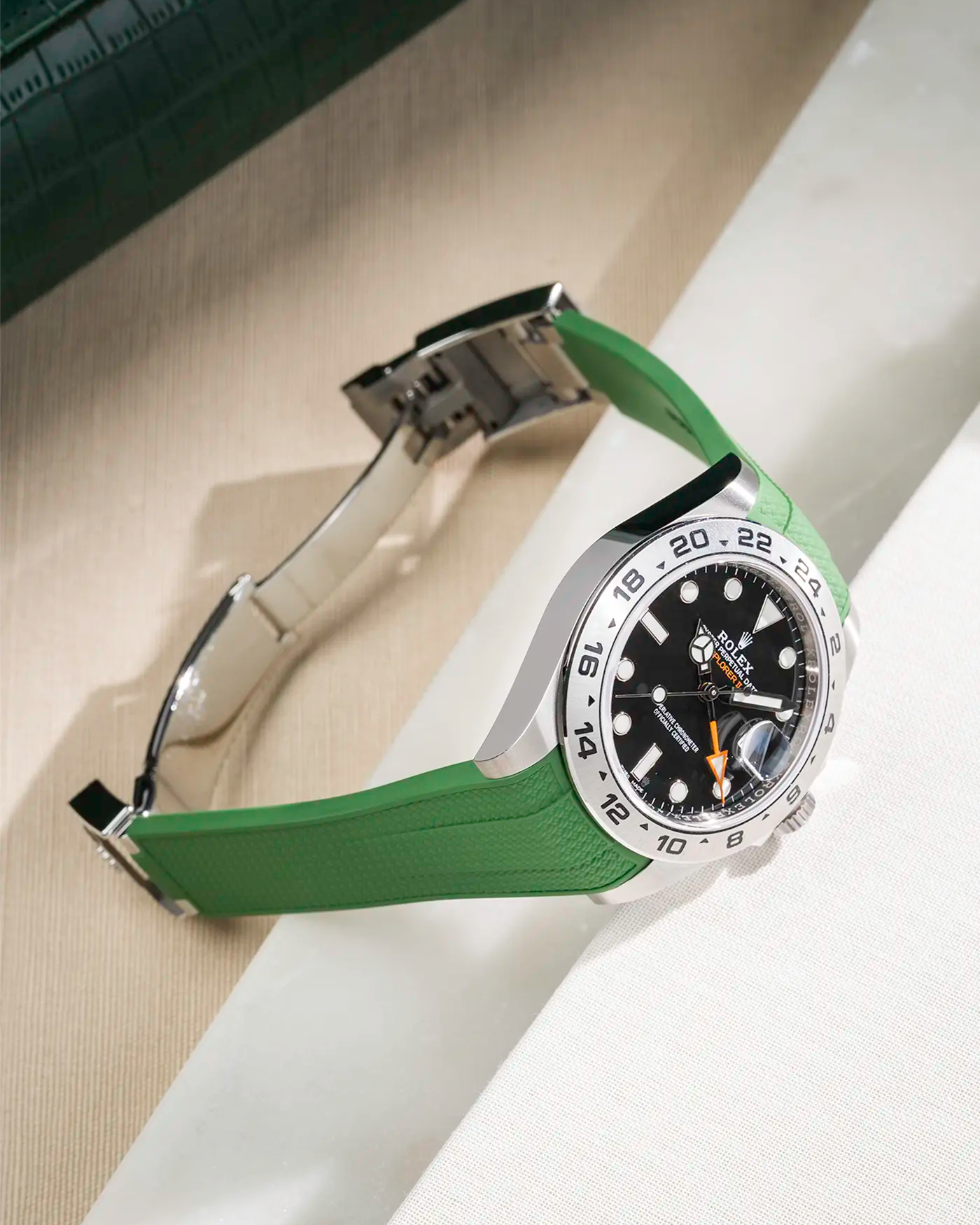 Vertech FKM rubber strap integrated with original clasp for Rolex Explorer 216570 in green, displayed on table with open clasp