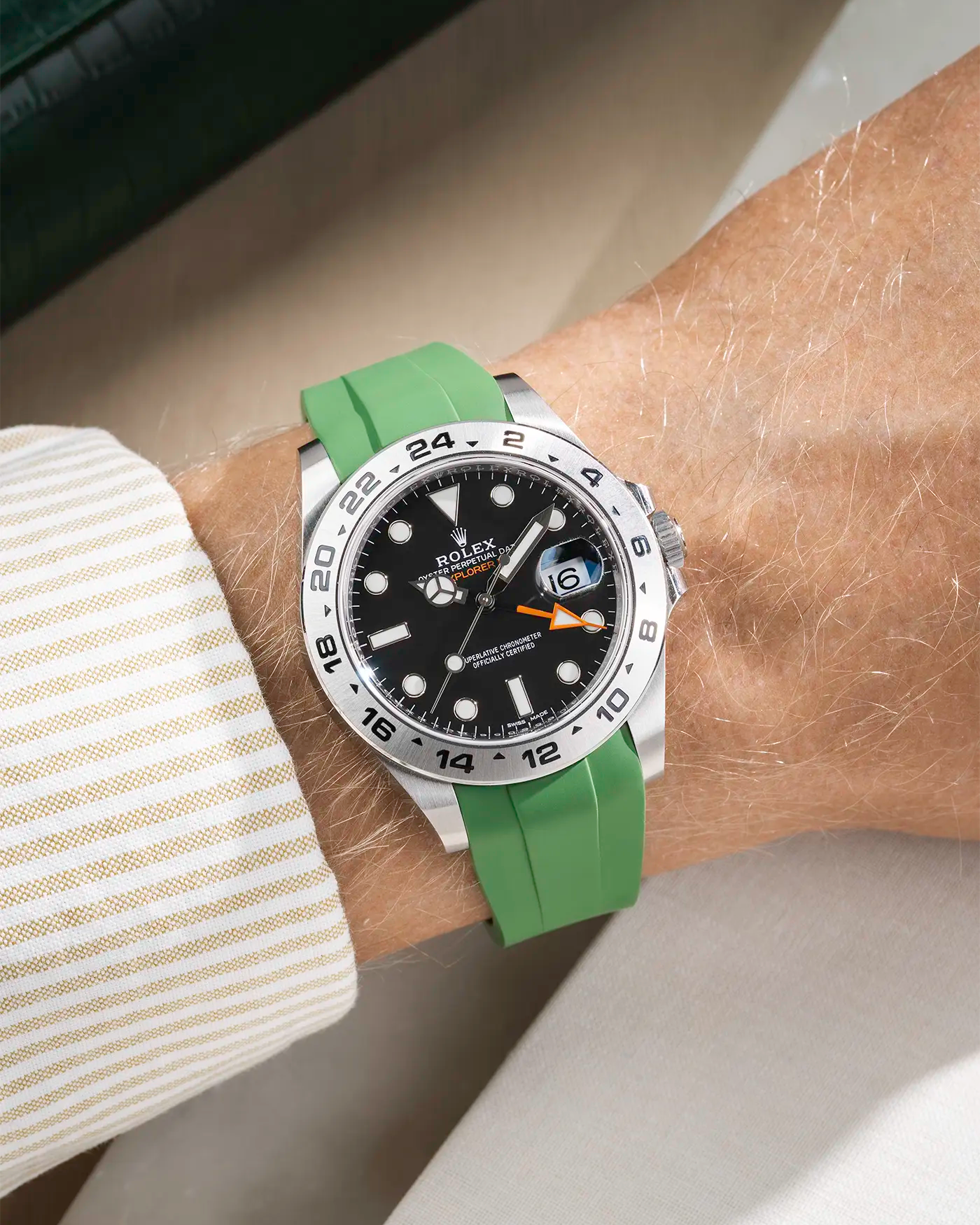Wrist shot on classic smooth green FKM Rubber Strap Integrated with Original Clasp - Rolex Explorer 216570 on beige background