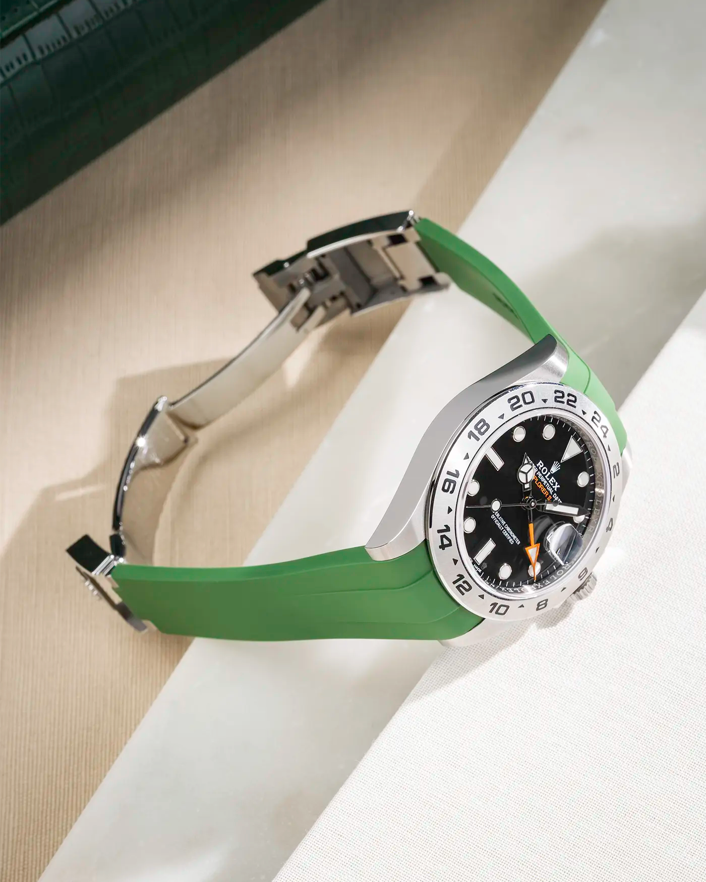 Green FKM rubber strap integrated with original clasp for Rolex Explorer 216570, displayed on table with open clasp