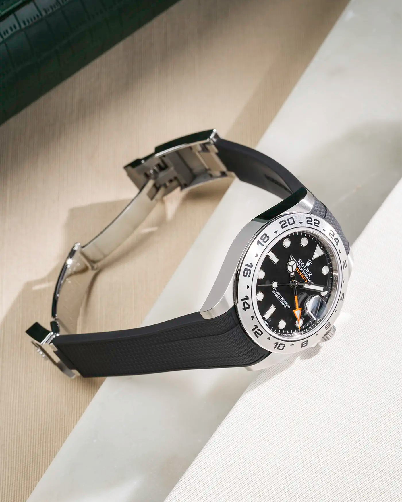 Vertech FKM rubber strap integrated with original clasp for Rolex Explorer 216570 in black, displayed on table with open clasp