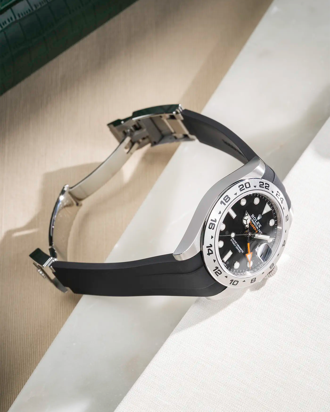 FKM rubber strap integrated with original clasp for Rolex Explorer 216570 in classic smooth black, displayed on table with open clasp