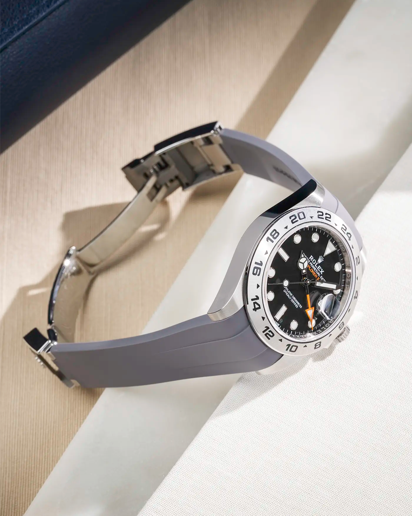 Grey FKM rubber strap integrated with original clasp for Rolex Explorer 216570, displayed on table with open clasp