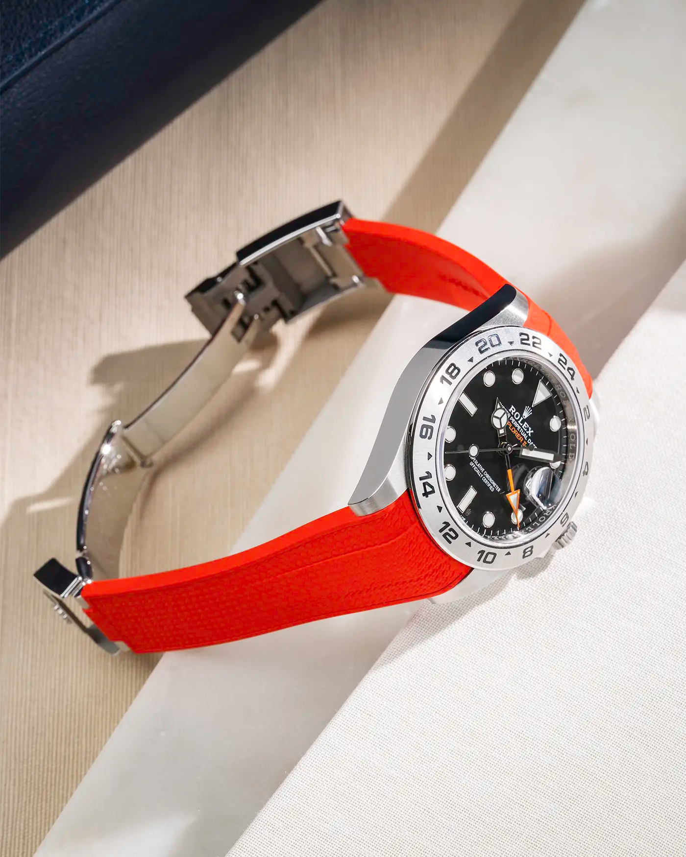 Vertech FKM rubber strap integrated with original clasp for Rolex Explorer 216570 in red, displayed on table with open clasp