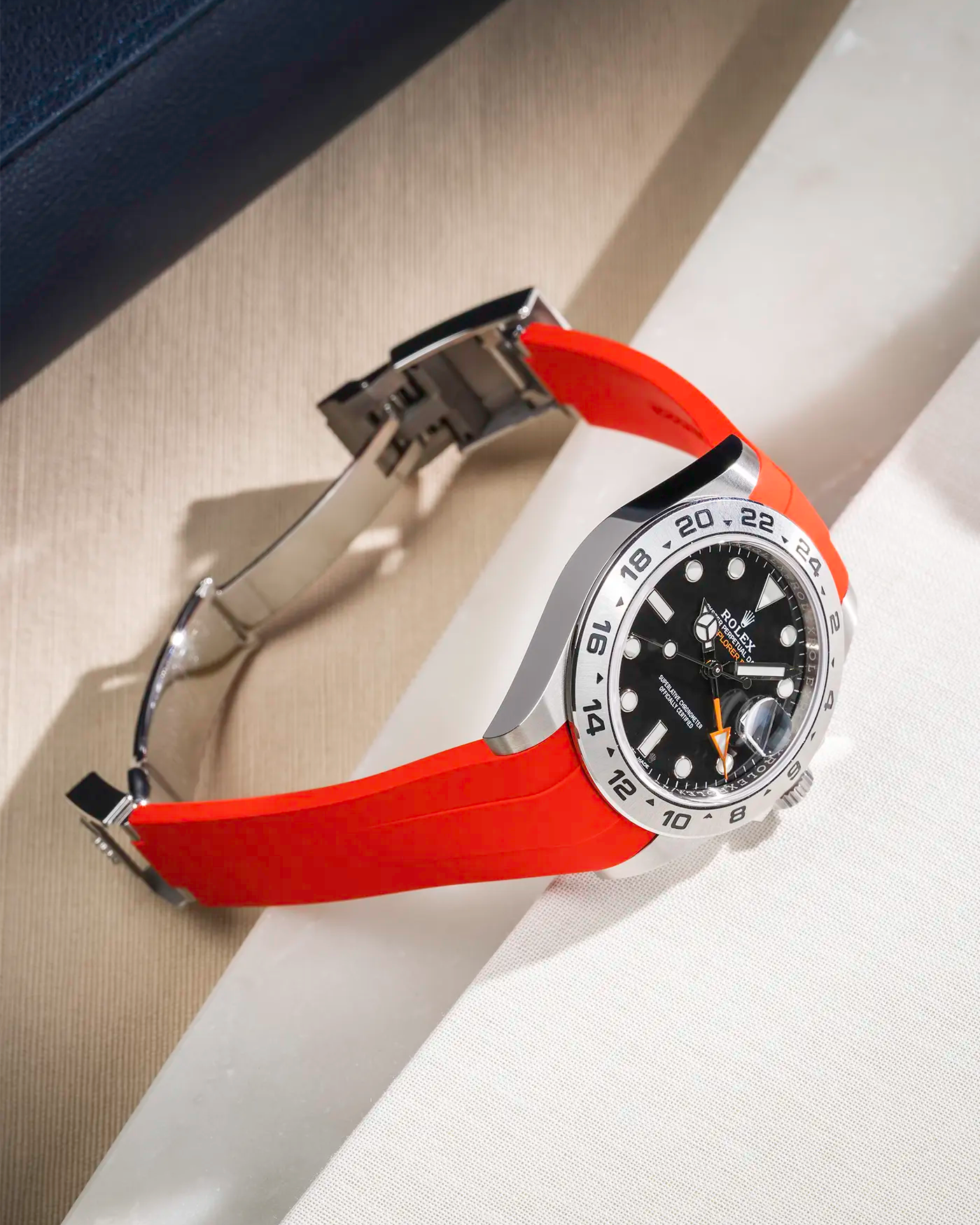 Classic Smooth Red FKM rubber strap integrated with original clasp for Rolex Explorer 216570, displayed on table with open clasp