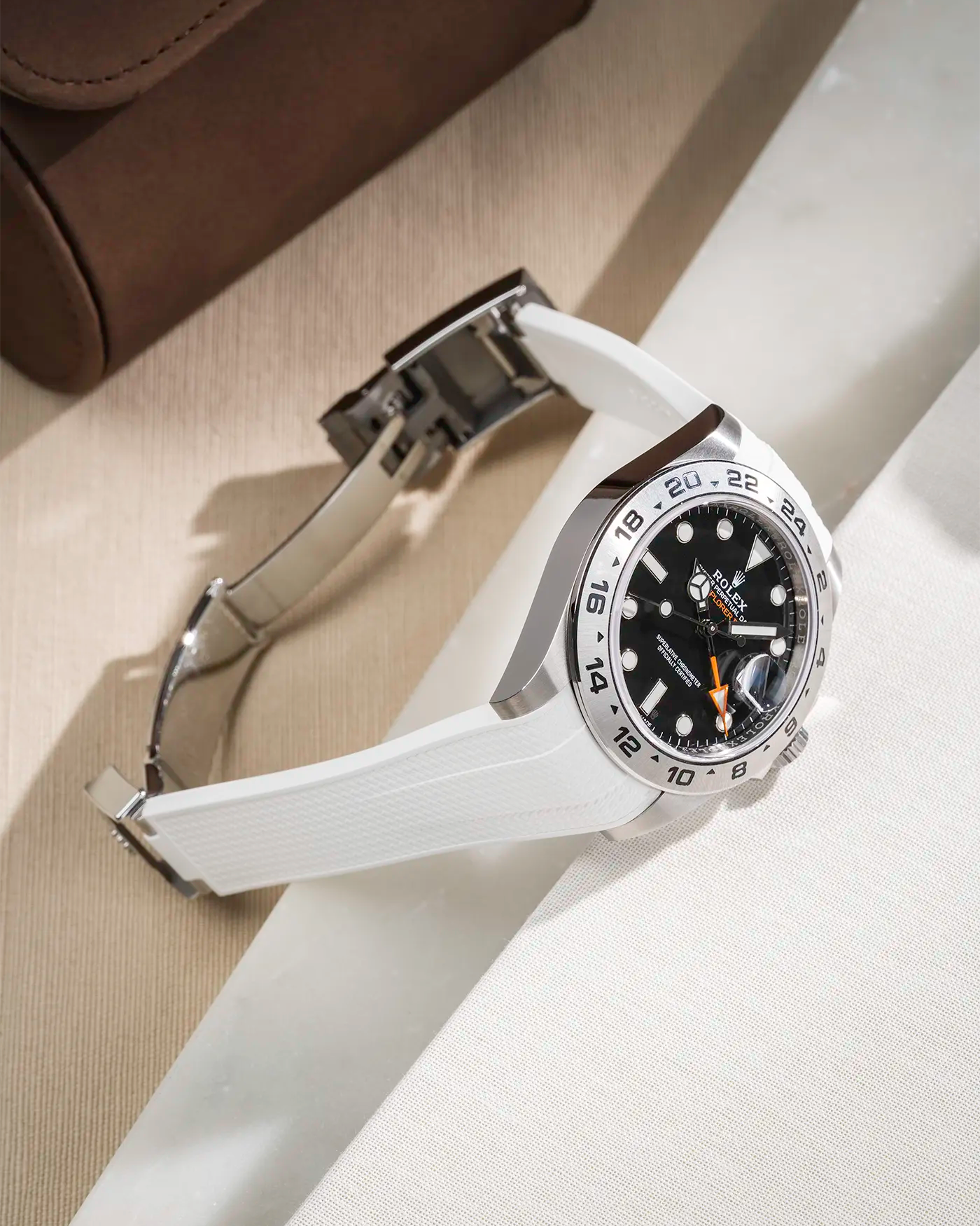 FKM rubber strap in Vertech integrated with original clasp for Rolex Explorer 216570 in white, displayed on a beige and white table with open clasp