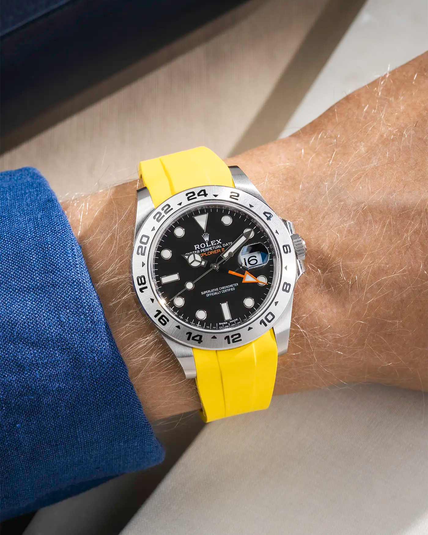 Wrist shot on yellow FKM Rubber Strap Integrated with Original Clasp - Rolex Explorer 216570 on beige background
