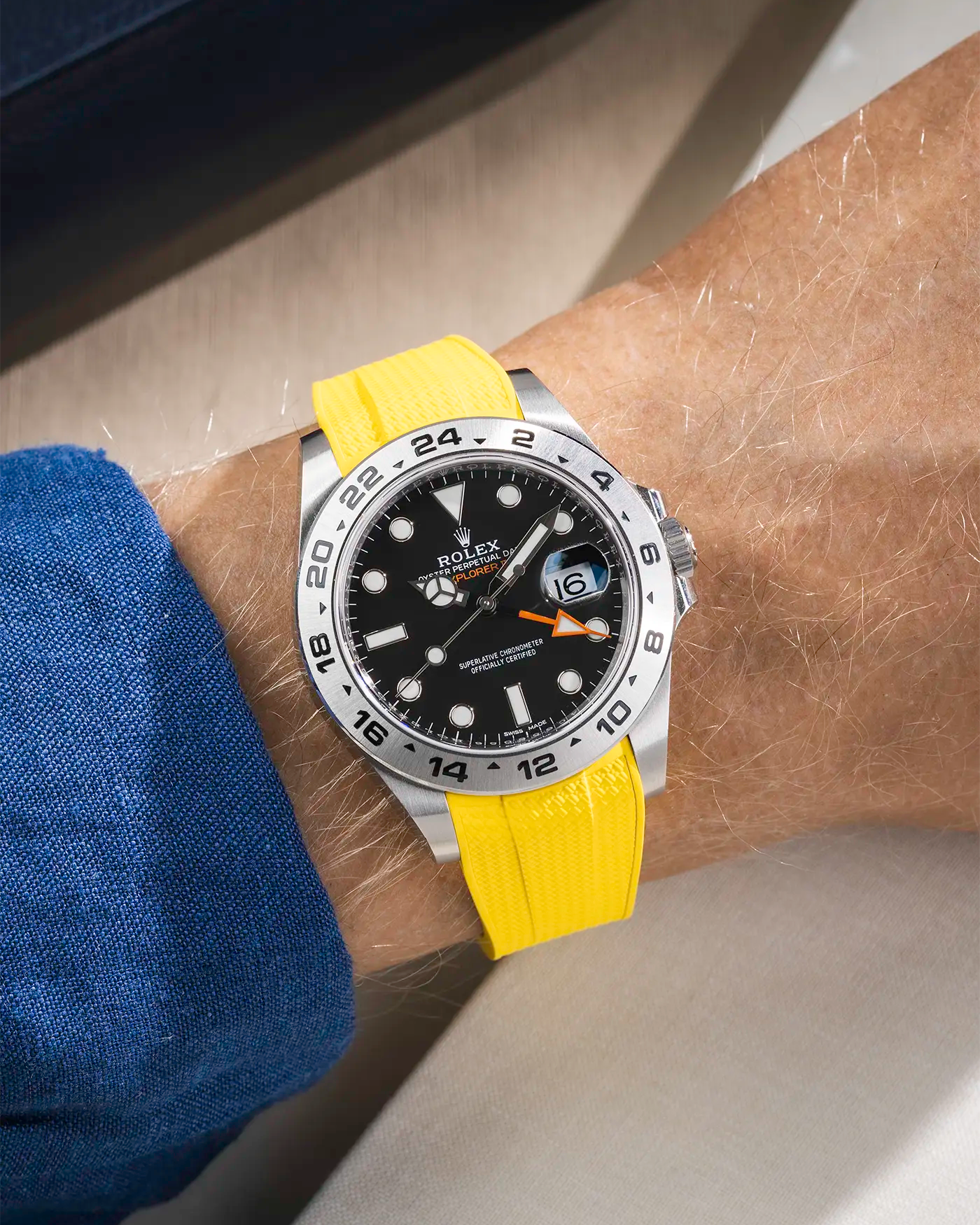 Wrist shot on Vertech FKM Rubber Strap in Yellow with Integrated Original Clasp - Rolex Explorer 216570 over a table with watch roll