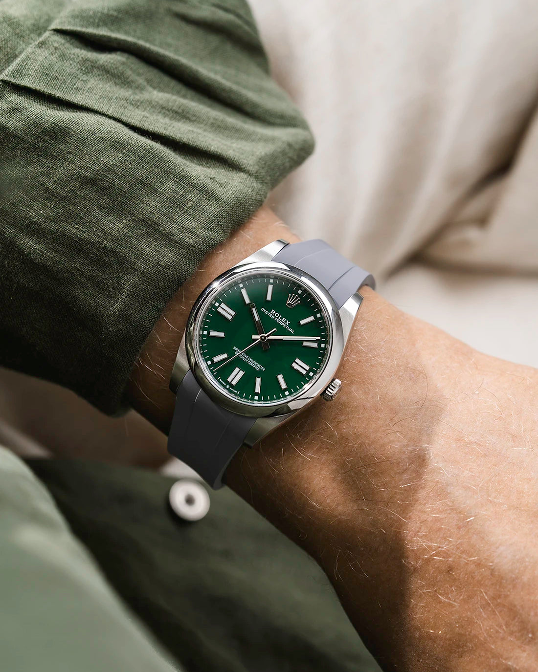 Grey integrated FKM rubber strap with original clasp on Rolex Oyster Perpetual 41 124300 green dial wrist shot