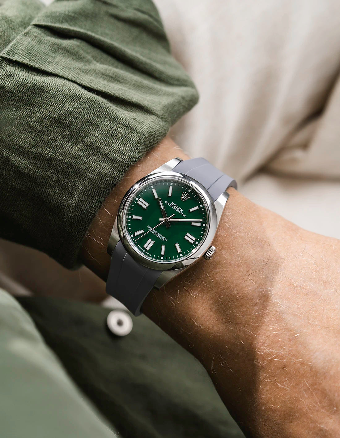 Grey integrated FKM rubber strap with original clasp on Rolex Oyster Perpetual 41 124300 green dial wrist shot