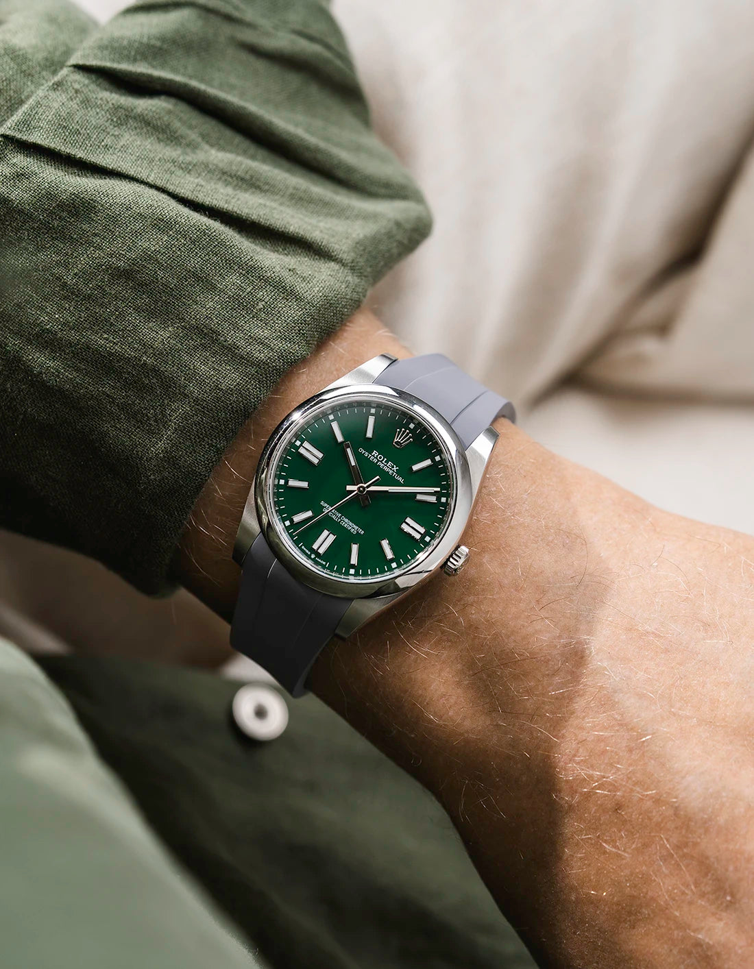 Grey integrated FKM rubber strap with original clasp on Rolex Oyster Perpetual 41 124300 green dial wrist shot