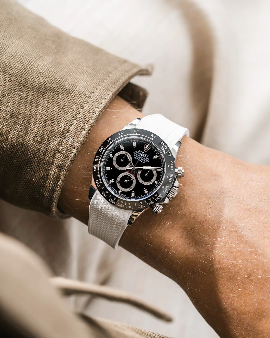 White integrated Vertech FKM rubber strap with original clasp on Rolex Daytona 116500 black dial ceramic bezel wrist shot textured surface