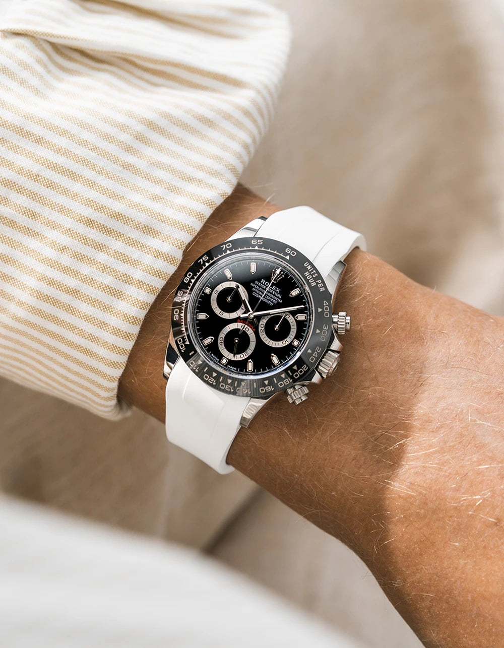 White integrated FKM rubber strap with original clasp on Rolex Daytona 116500 black dial ceramic bezel wrist shot classic smooth surface