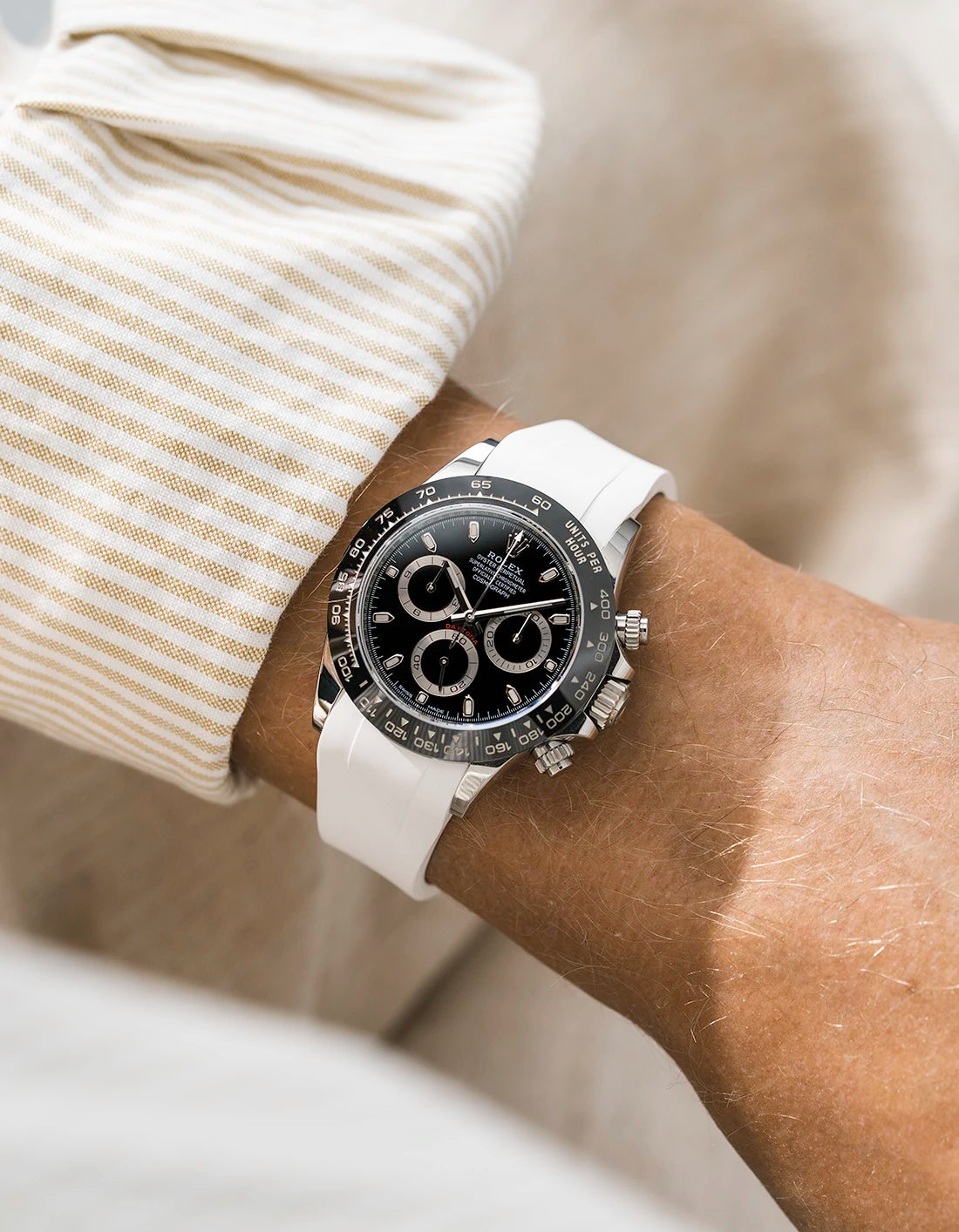 White integrated FKM rubber strap with original clasp on Rolex Daytona 116500 black dial ceramic bezel wrist shot classic smooth surface